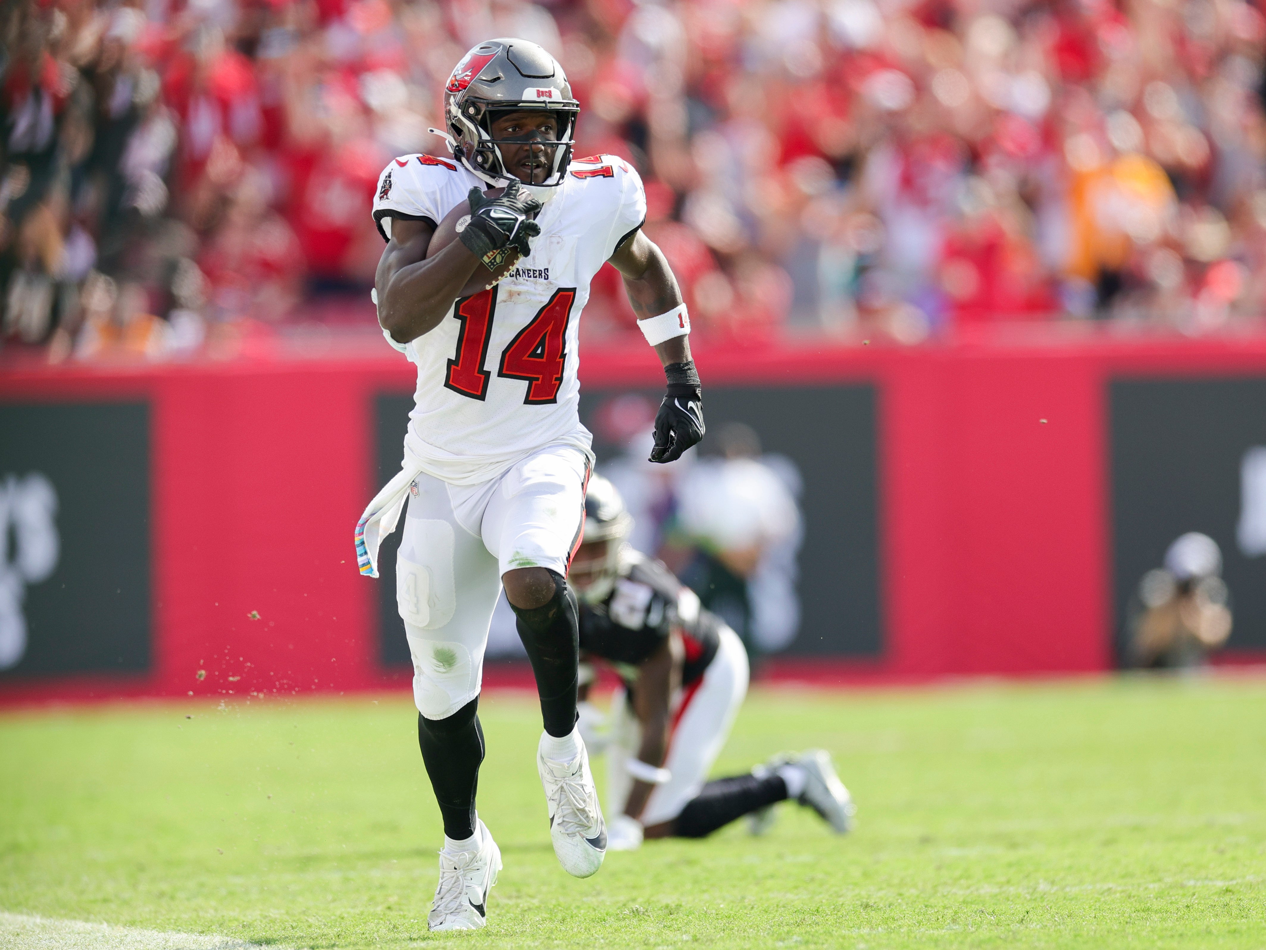 Oct 22, 2023; Tampa, Florida, USA; Tampa Bay Buccaneers wide receiver Chris Godwin (14) runs with the ball against the Atlanta Falcon in the fourth quarter at Raymond James Stadium. Mandatory Credit: Nathan Ray Seebeck-USA TODAY Sports