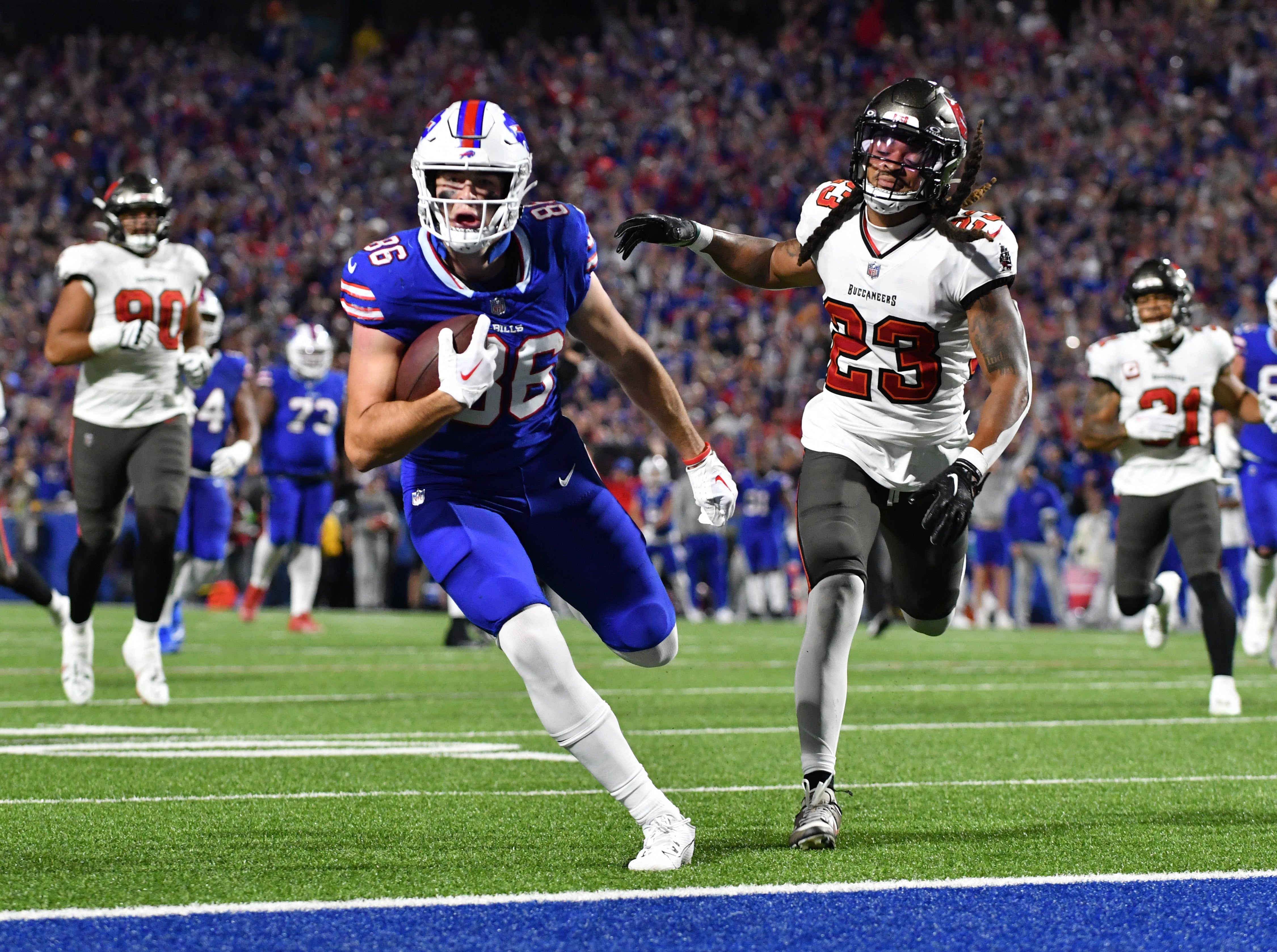 Oct 26, 2023; Orchard Park, New York, USA; Buffalo Bills tight end Dalton Kincaid (86) scores a touchdown as Tampa Bay Buccaneers safety Ryan Neal (23) defends in the second quarter at Highmark Stadium. Mandatory Credit: Mark Konezny-USA TODAY Sports