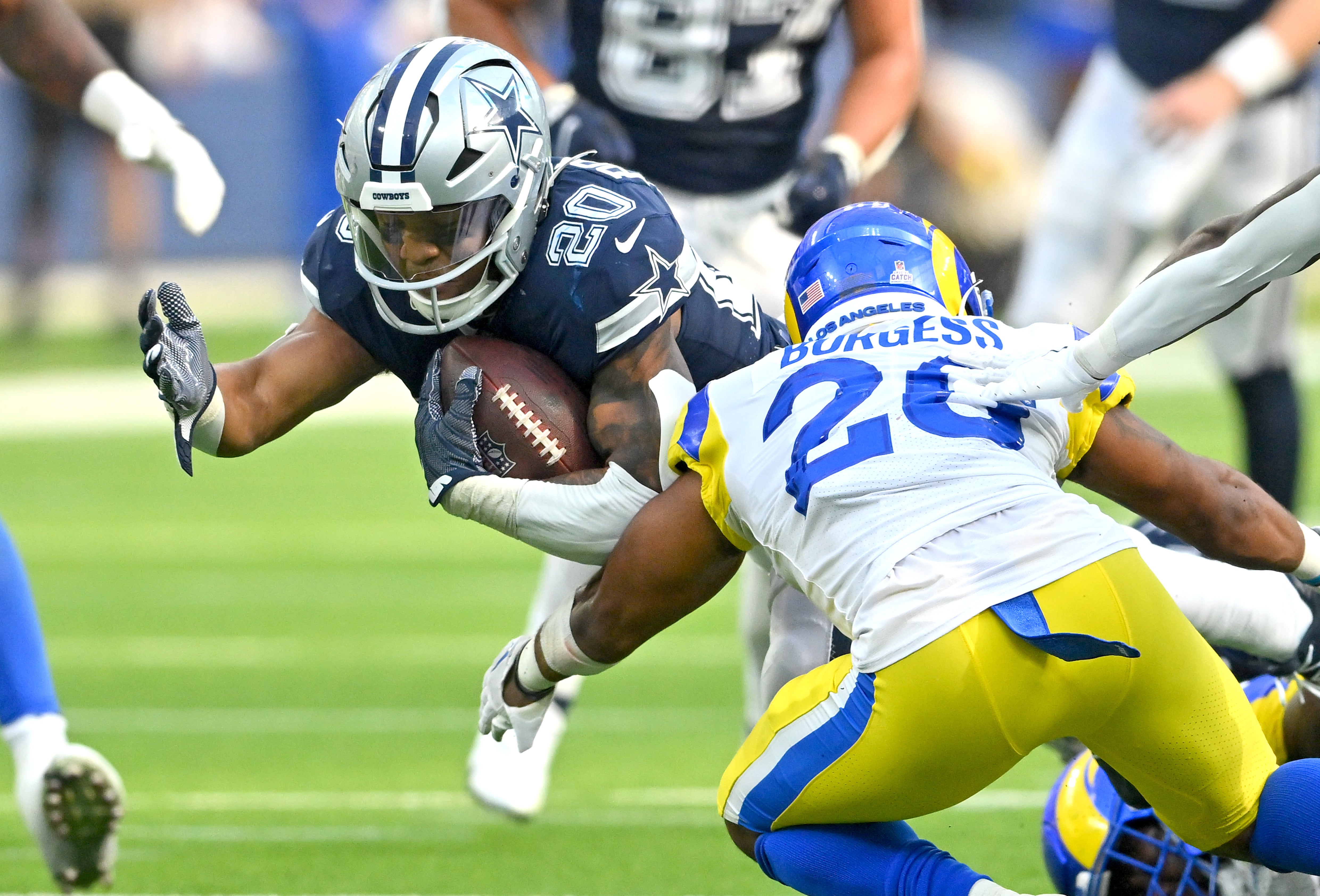 Dallas Cowboys running back Tony Pollard (20) is stopped by Los Angeles Rams safety Terrell Burgess (26) after a short gain in the second half at SoFi Stadium. Mandatory Credit: Jayne Kamin-Oncea-USA TODAY Sports