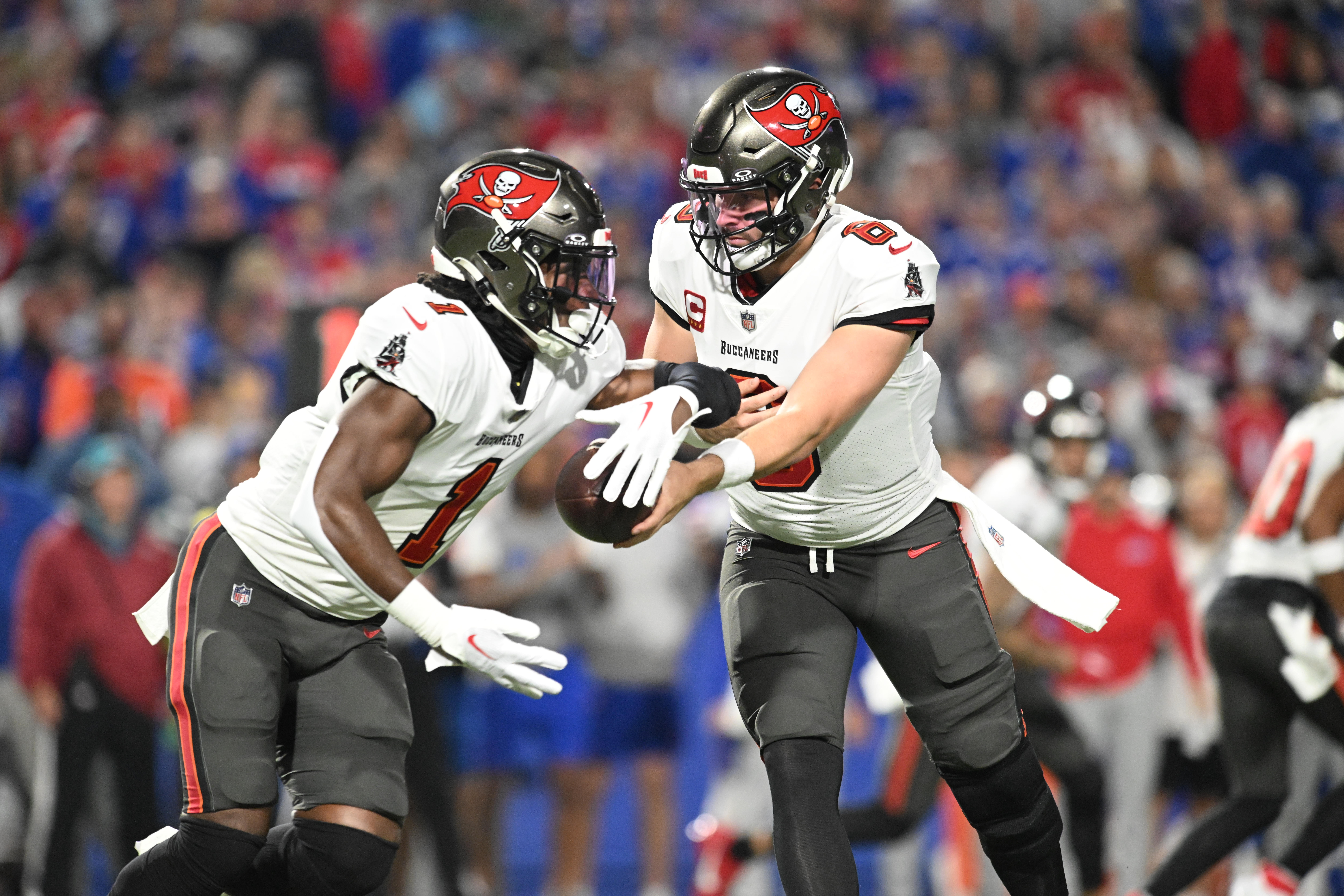 Oct 26, 2023; Orchard Park, New York, USA; Tampa Bay Buccaneers quarterback Baker Mayfield (6) hands the ball to running back Rachaad White (1) in the first quarter against the Buffalo Bills at Highmark Stadium. Mandatory Credit: Mark Konezny-USA TODAY Sports