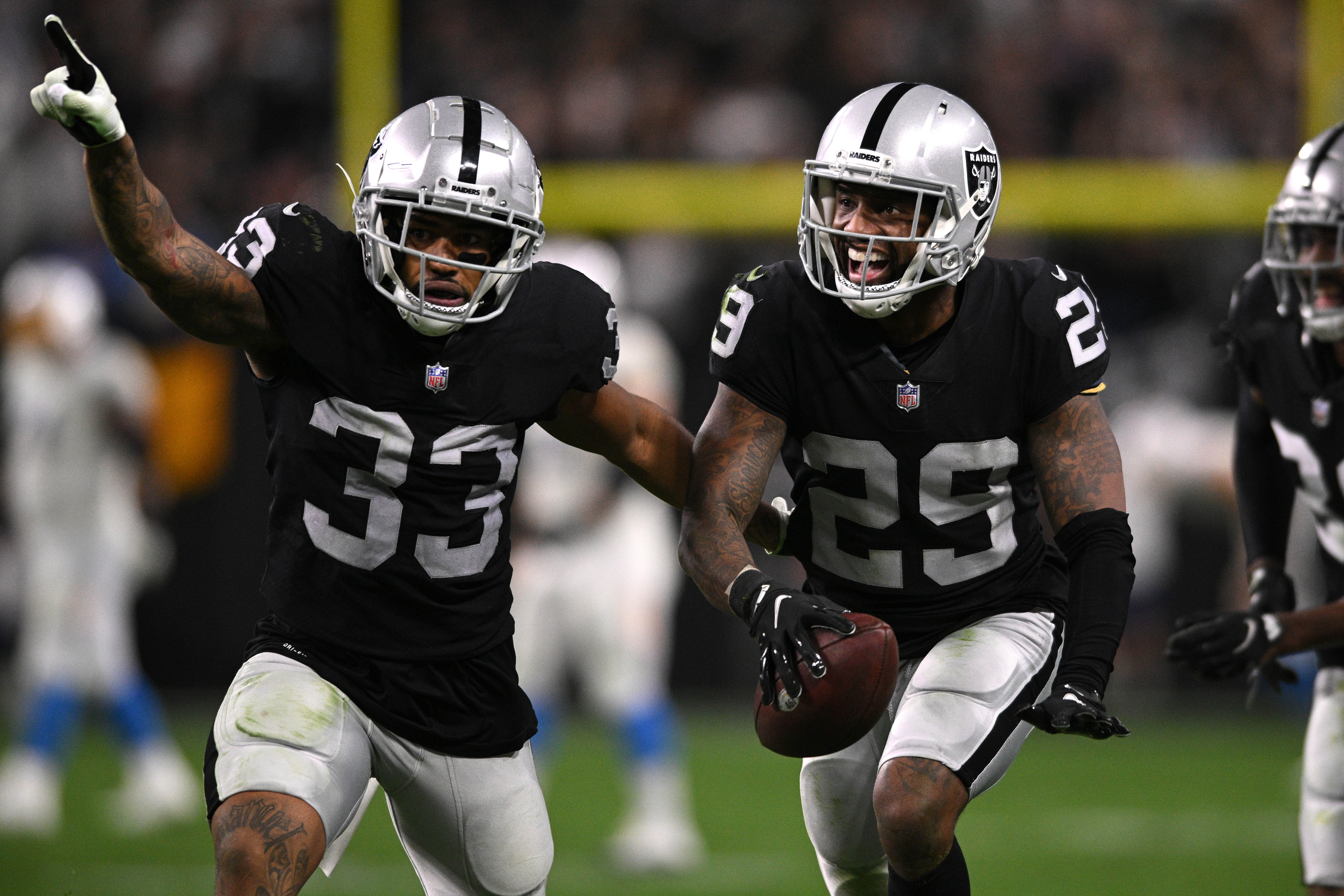 Jan 9, 2022; Paradise, Nevada, USA; Las Vegas Raiders cornerback Casey Hayward (29) celebrates with safety Roderic Teamer (33) after an interception during the second half against the Los Angeles Chargers at Allegiant Stadium.