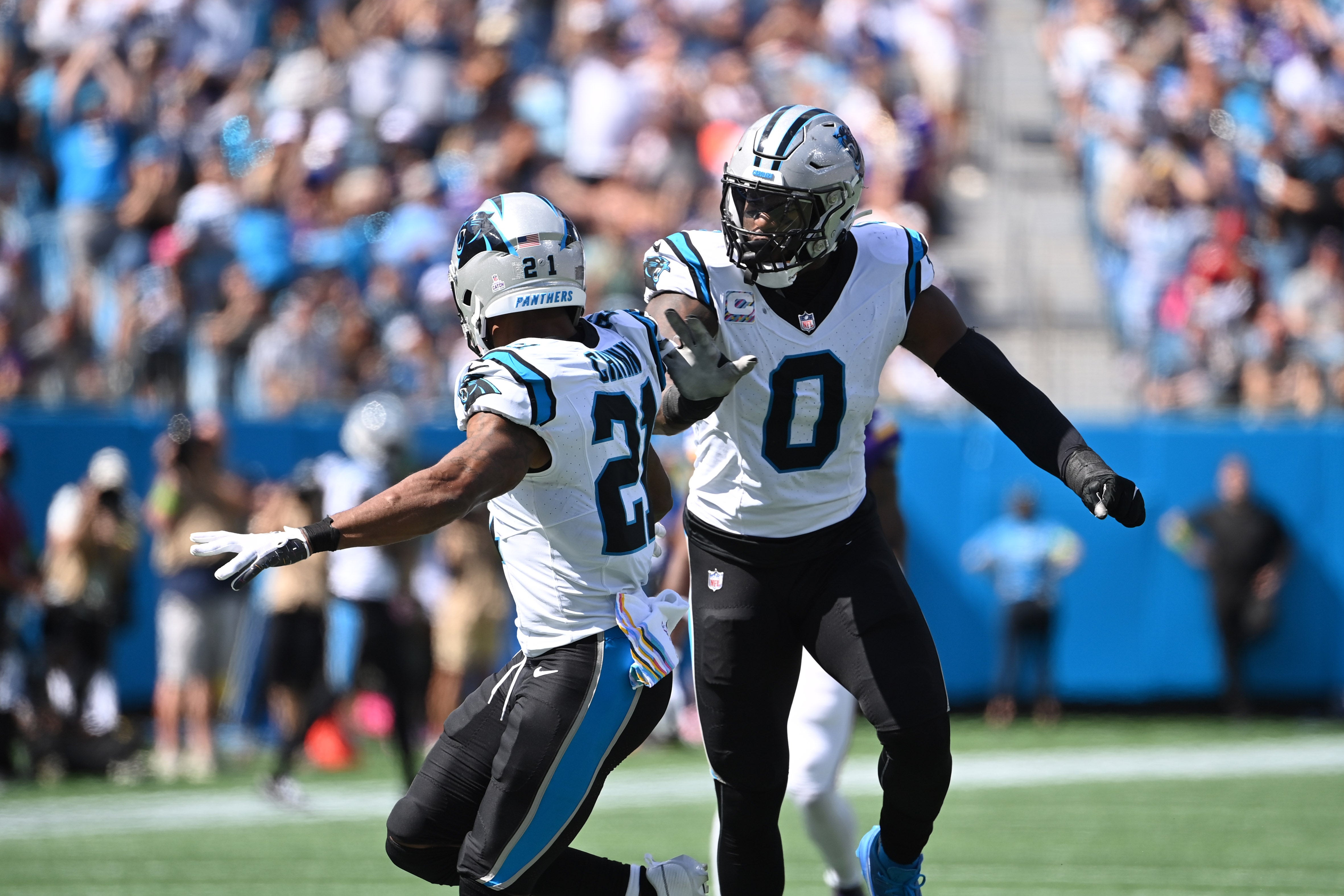 Oct 1, 2023; Charlotte, North Carolina, USA; Carolina Panthers safety Jeremy Chinn (21) reacts with linebacker Brian Burns (0) after a sack in the second quarter at Bank of America Stadium. Mandatory Credit: Bob Donnan-USA TODAY Sports