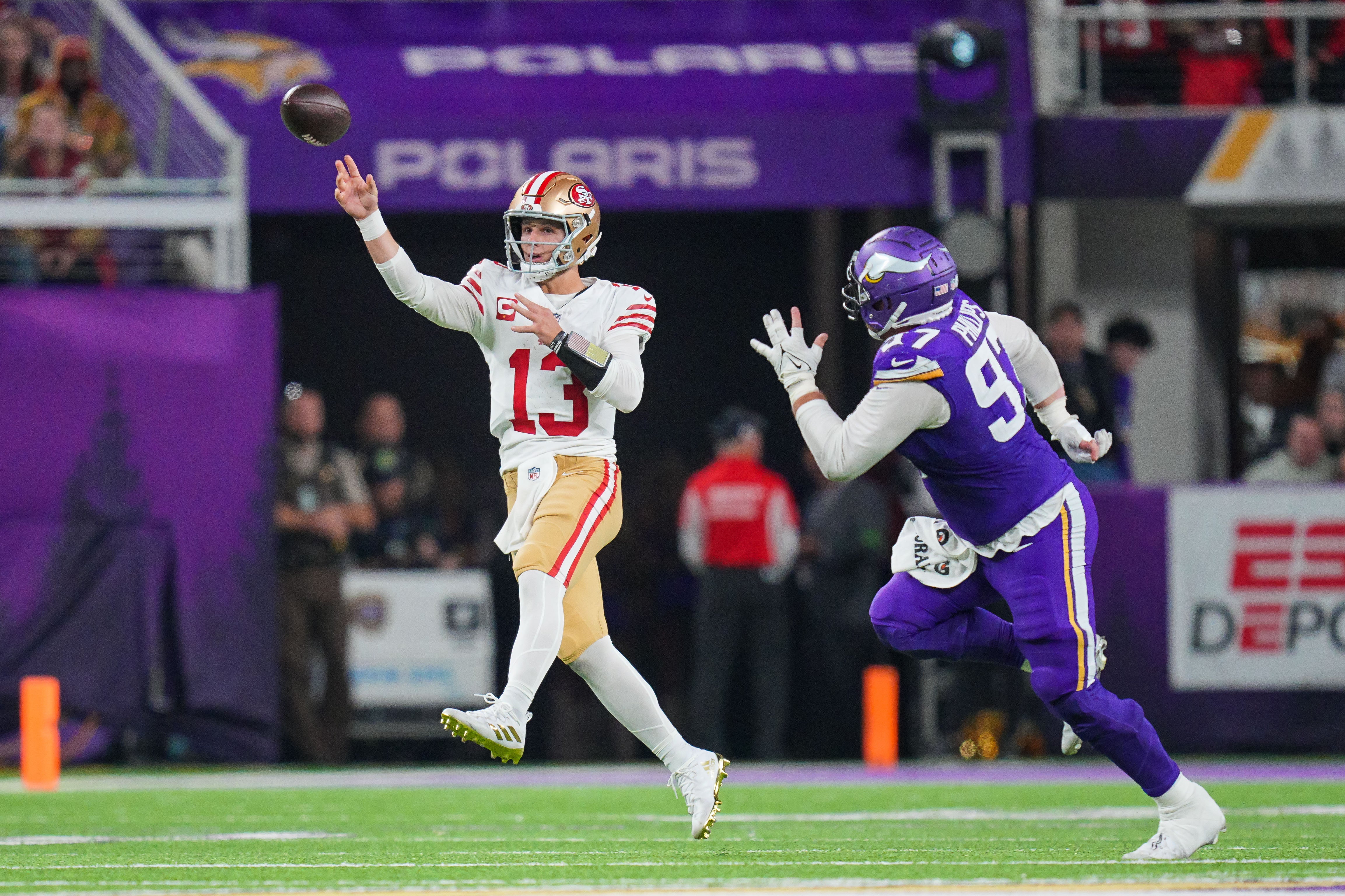 Oct 23, 2023; Minneapolis, Minnesota, USA; San Francisco 49ers quarterback Brock Purdy (13) passes against the Minnesota Vikings defensive tackle Harrison Phillips (97) in the fourth quarter at U.S. Bank Stadium.