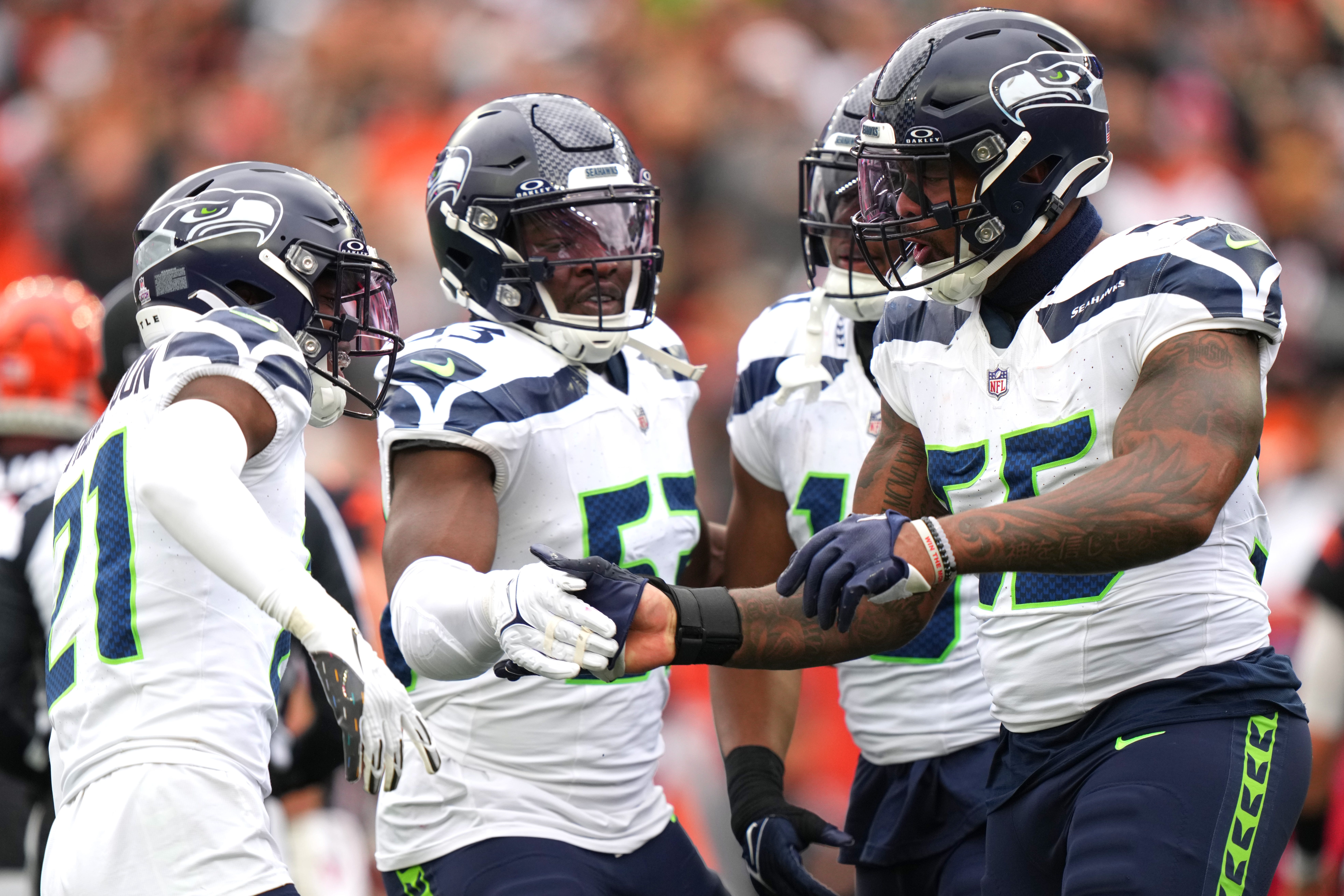 Seattle Seahawks defensive end Dre'Mont Jones (55) is congratulated by Seattle Seahawks linebacker Boye Mafe (53) and Seattle Seahawks cornerback Devon Witherspoon (21) after a sack in the third quarter during an NFL football game between the Seattle Seahawks and the Cincinnati Bengals Sunday, Oct. 15, 2023, at Paycor Stadium in Cincinnati.