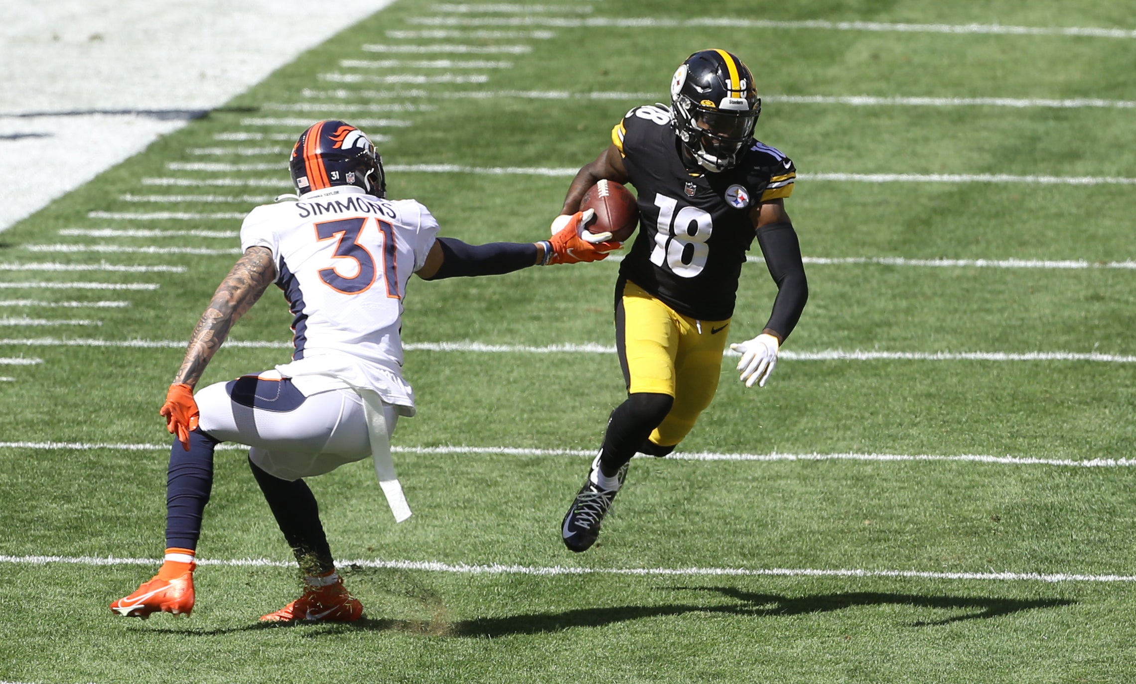 Sep 20, 2020; Pittsburgh, Pennsylvania, USA; Pittsburgh Steelers wide receiver Diontae Johnson (18) runs after a catch as Denver Broncos free safety Justin Simmons (31) defends during the second quarter at Heinz Field. Mandatory Credit: Charles LeClaire-USA TODAY Sports