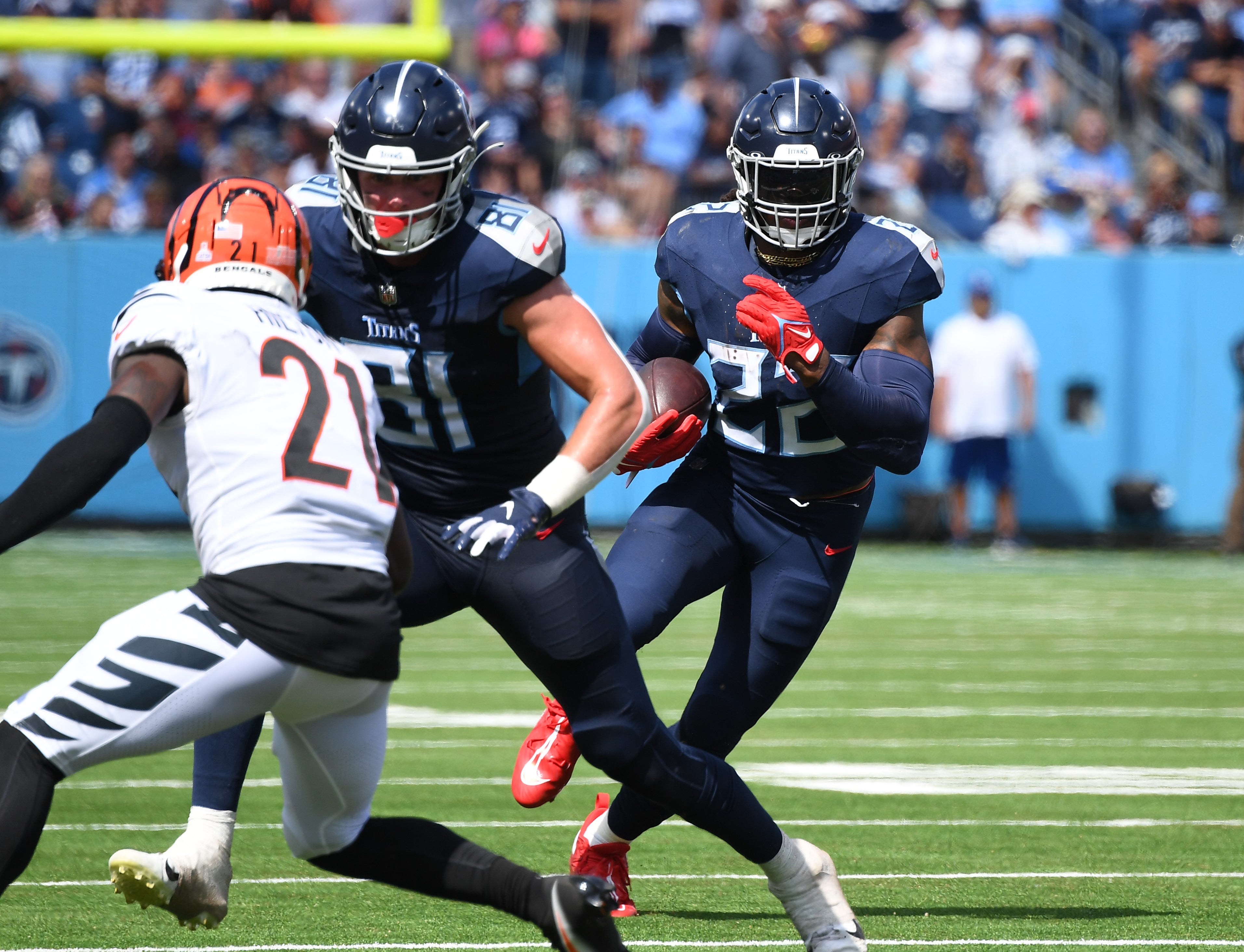 Tennessee Titans running back Derrick Henry (22) runs for a first down during the first half against the Cincinnati Bengals at Nissan Stadium.