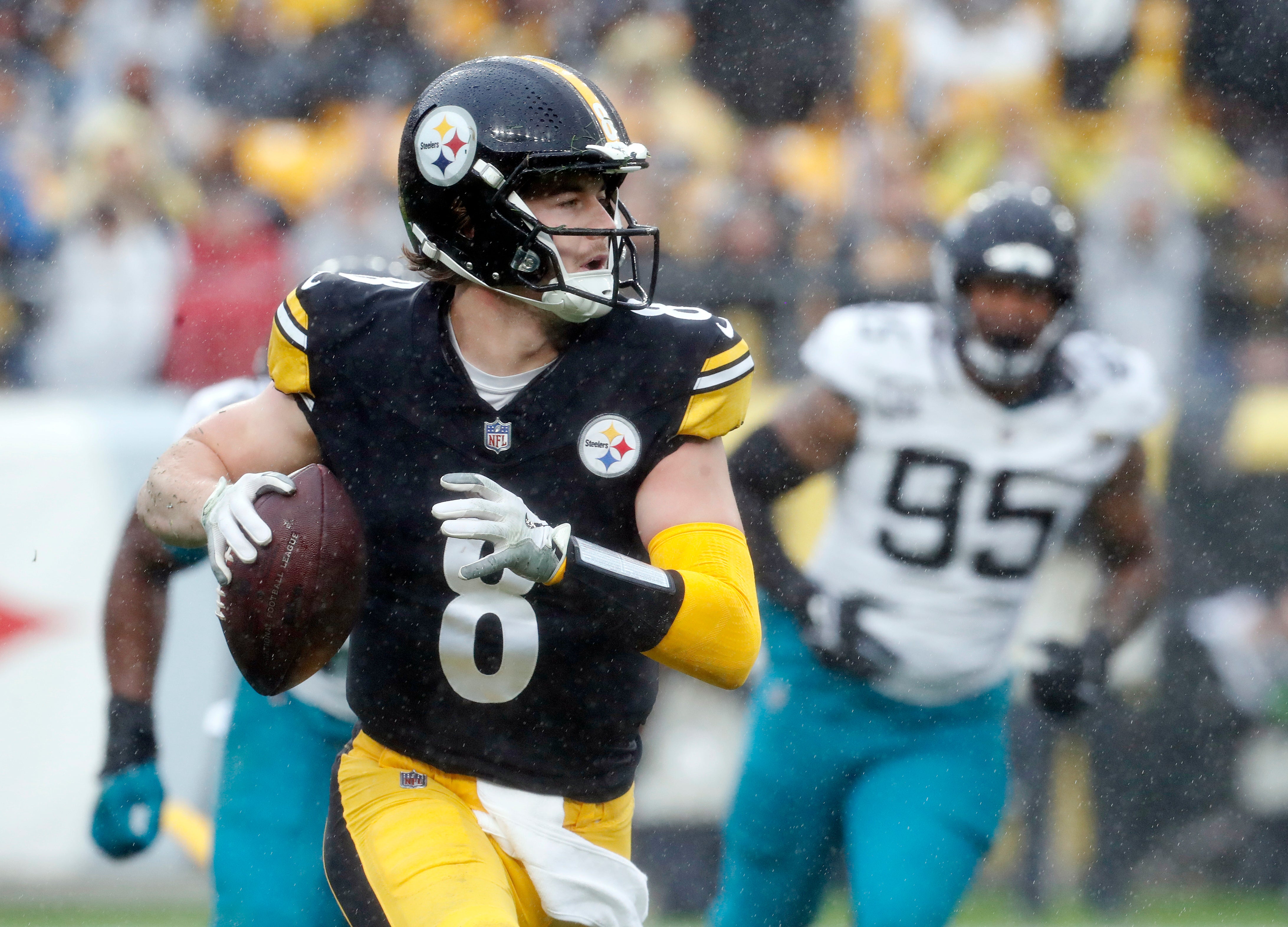 Oct 29, 2023; Pittsburgh, Pennsylvania, USA; Pittsburgh Steelers quarterback Kenny Pickett (8) scrambles with the ball against the Jacksonville Jaguars during the first quarter at Acrisure Stadium. Mandatory Credit: Charles LeClaire-USA TODAY Sports