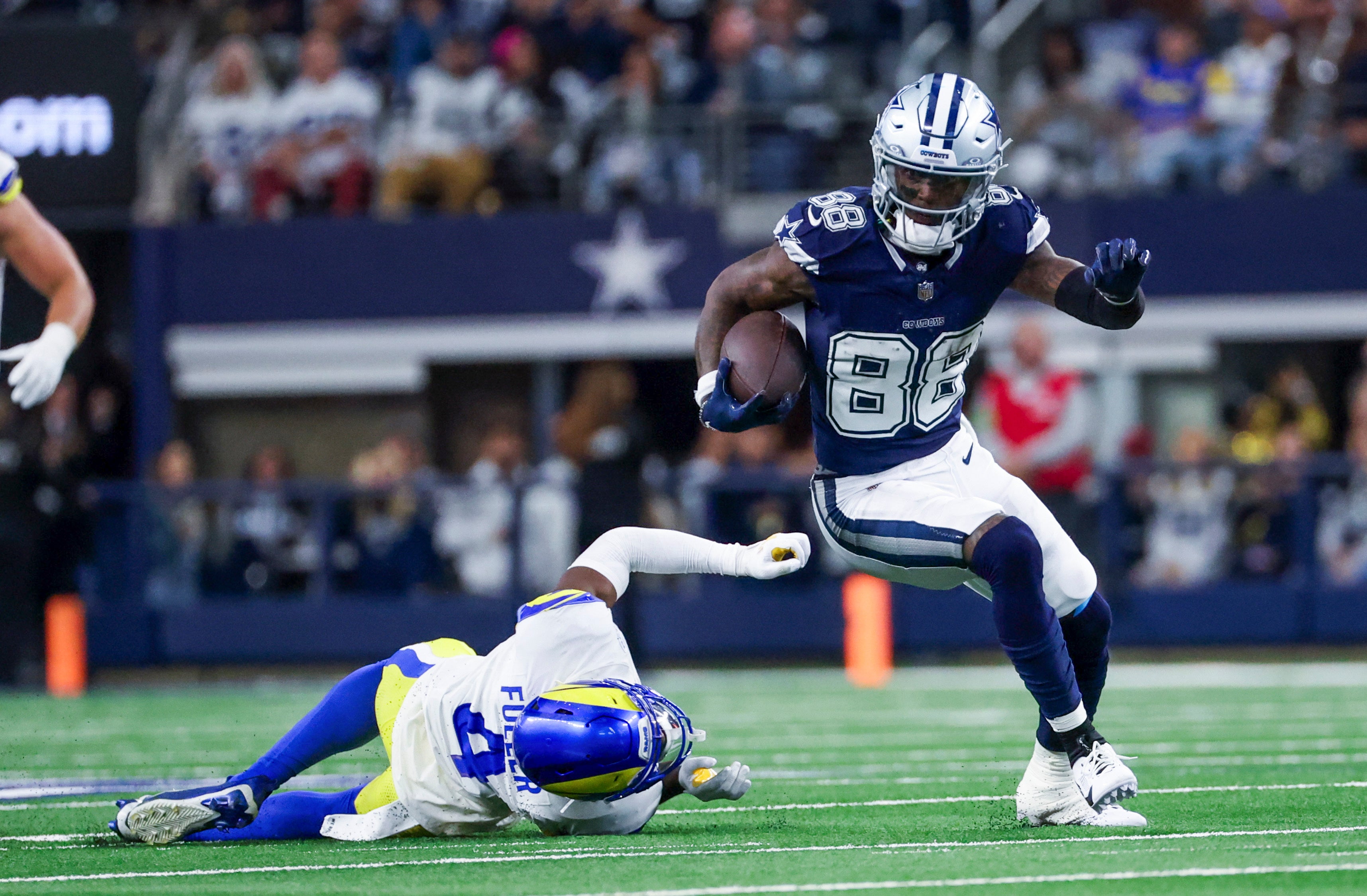 Dallas Cowboys wide receiver CeeDee Lamb (88) runs with the ball as Los Angeles Rams safety Jordan Fuller (4) defends during the first half at AT&T Stadium.