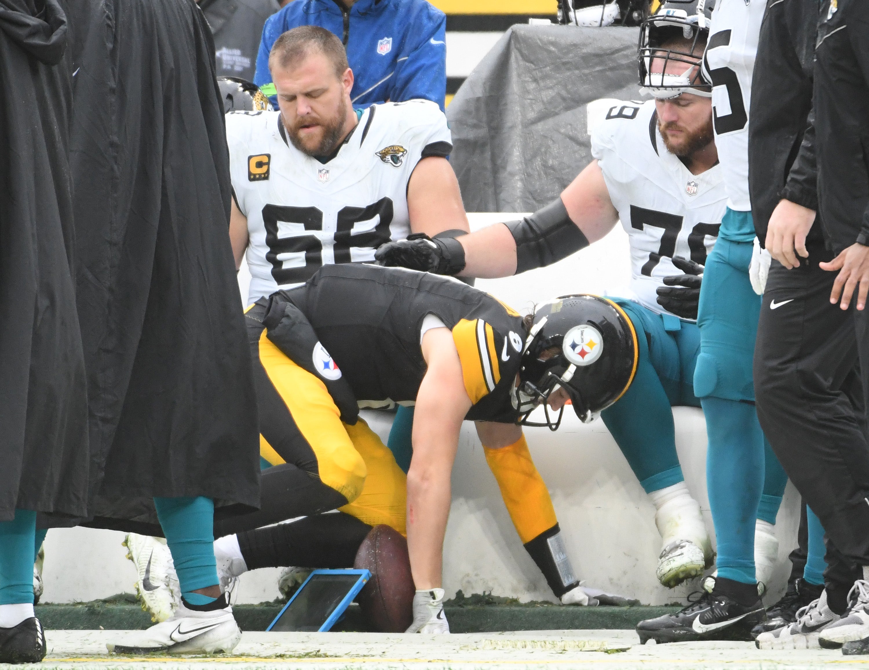 Oct 29, 2023; Pittsburgh, Pennsylvania, USA; Pittsburgh Steelers quarterback Kenny Pickett (8) is knocked into the Jacksonville Jaguars bench area during the second quarter at Acrisure Stadium. Mandatory Credit: Philip G. Pavely-USA TODAY Sports  