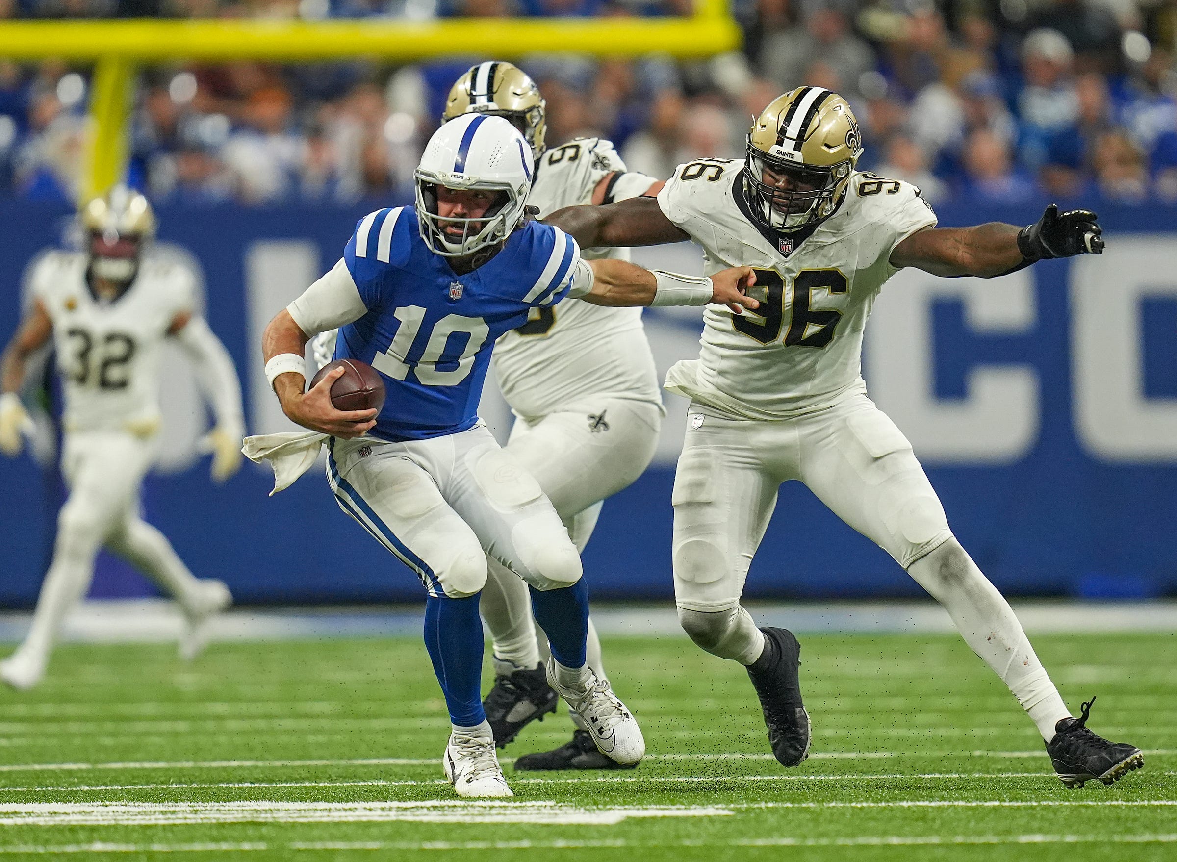 Indianapolis Colts quarterback Gardner Minshew II (10) fights off Saints defenders Sunday, Oct. 29, 2023, at Lucas Oil Stadium in Indianapolis. The Colts lost to the Saints, 38-27.