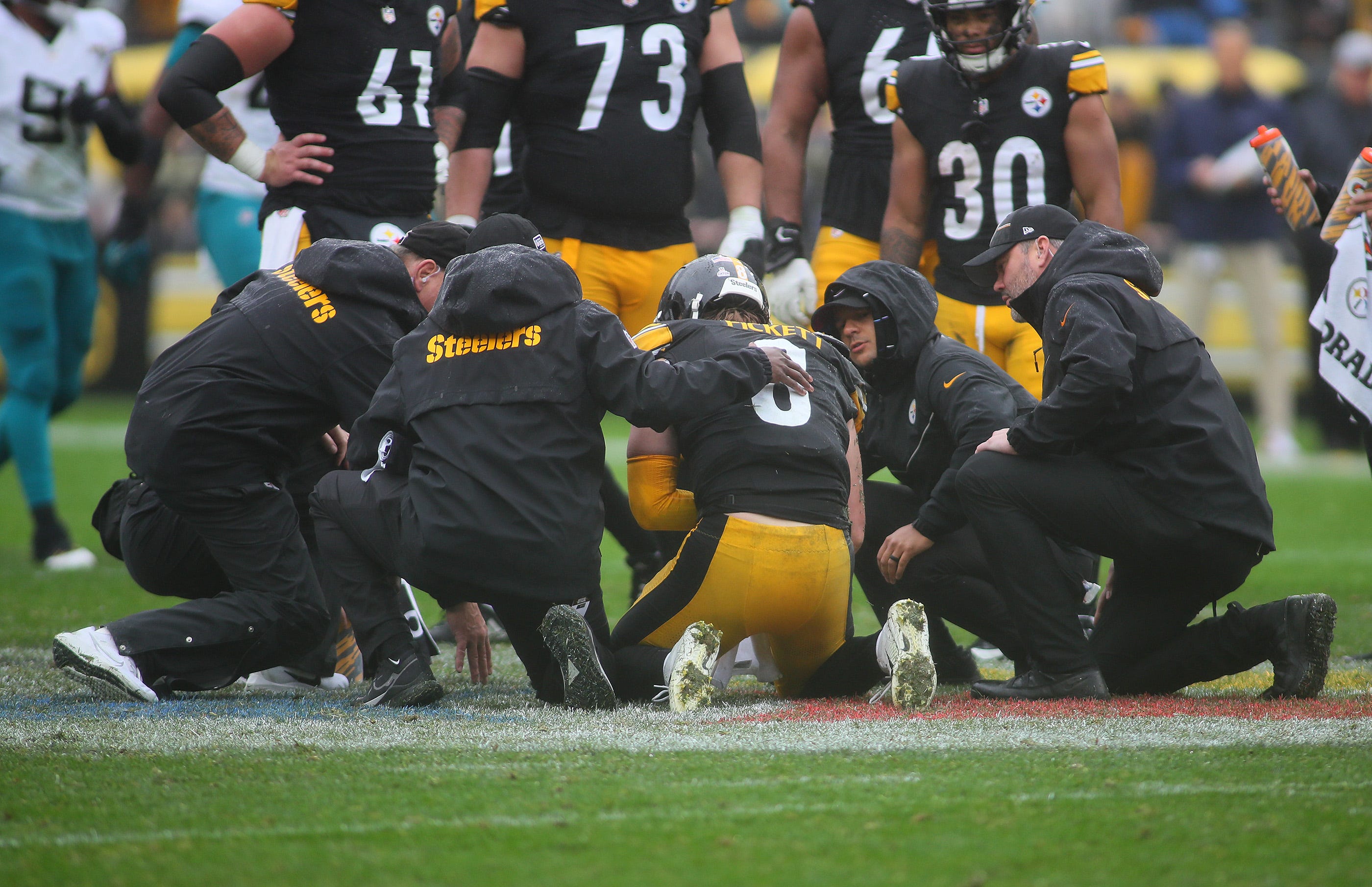 Pittsburgh Steelers quarterback Kenny Pickett (8) gets looked at by the Steelers medical staff after a hard hit during the first half against the Jacksonville Jaguars at Acrisure Stadium in Pittsburgh, PA on October 29, 2023.