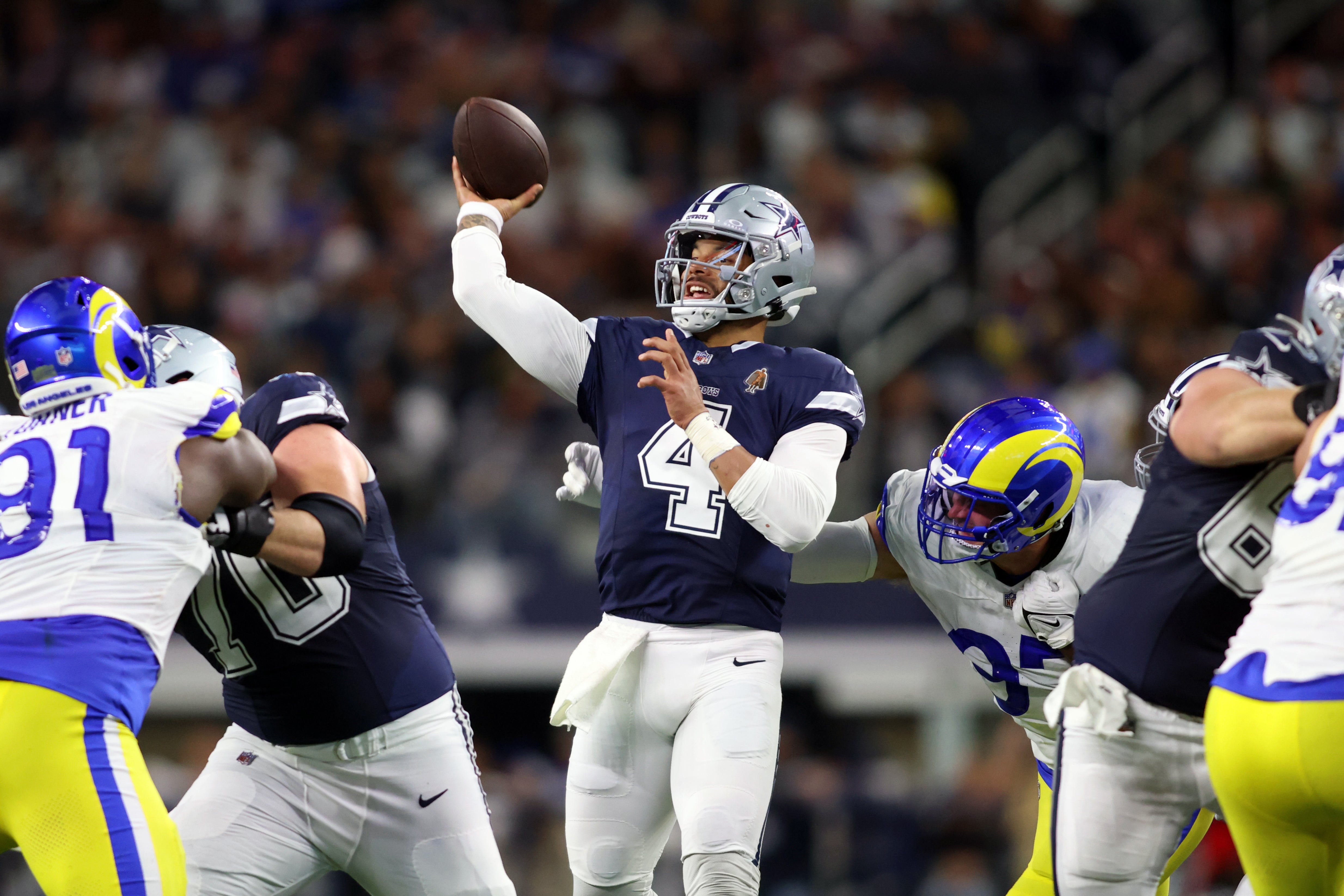 Dallas Cowboys quarterback Dak Prescott (4) throws a pass in the third quarter against the Los Angeles Rams at AT&T Stadium.