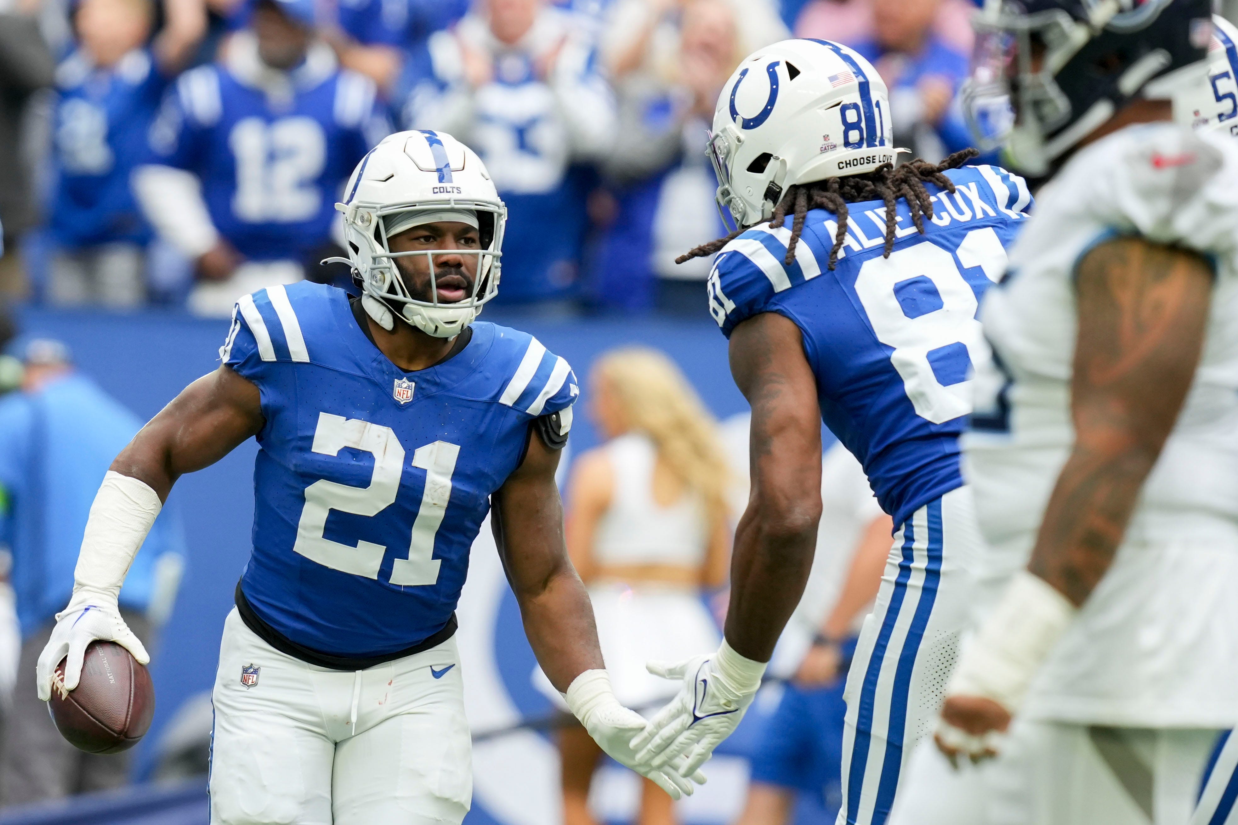 Indianapolis Colts running back Zack Moss (21) gets a high five from Indianapolis Colts tight end Mo Alie-Cox (81) after rushing for a touchdown Sunday, Oct. 8, 2023, during a game against the Tennessee Titans at Lucas Oil Stadium in Indianapolis.