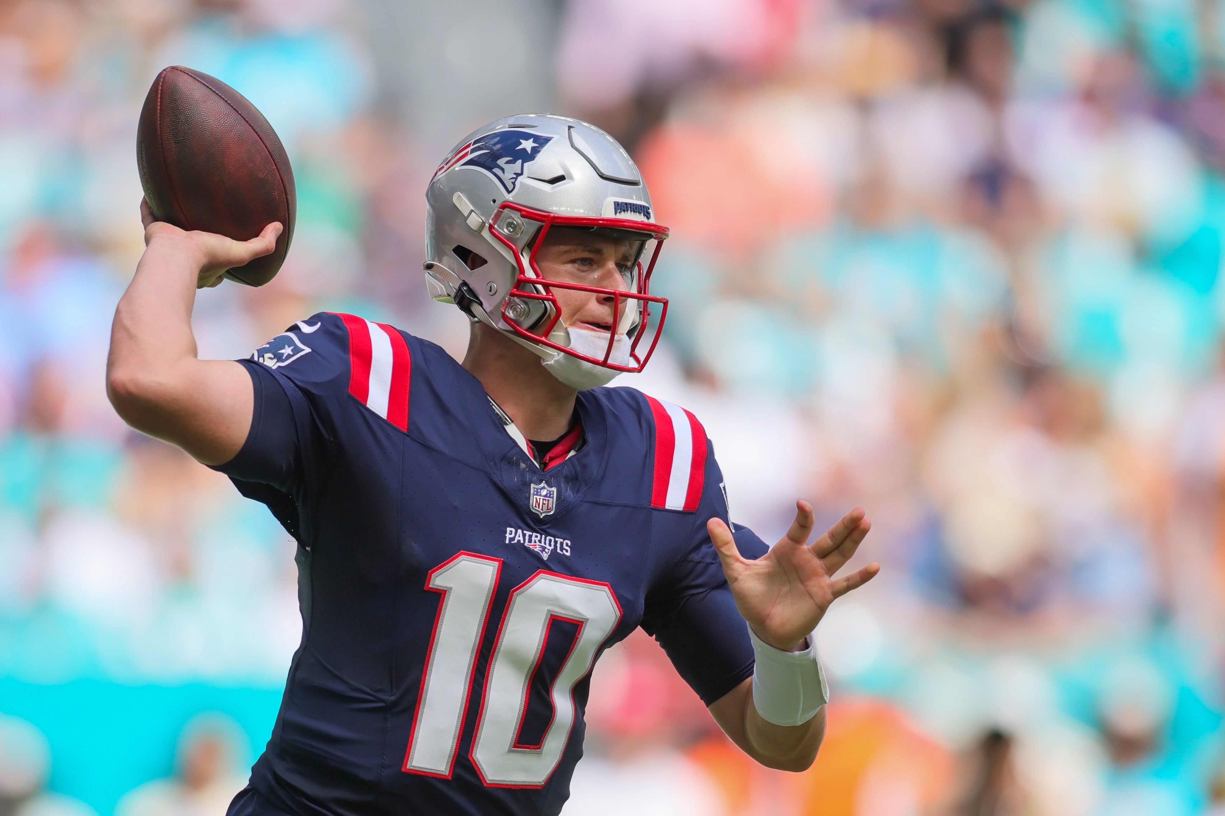 Patriots quarterback Mac Jones throws the football against the Miami Dolphins during the first quarter of Week 8 loss