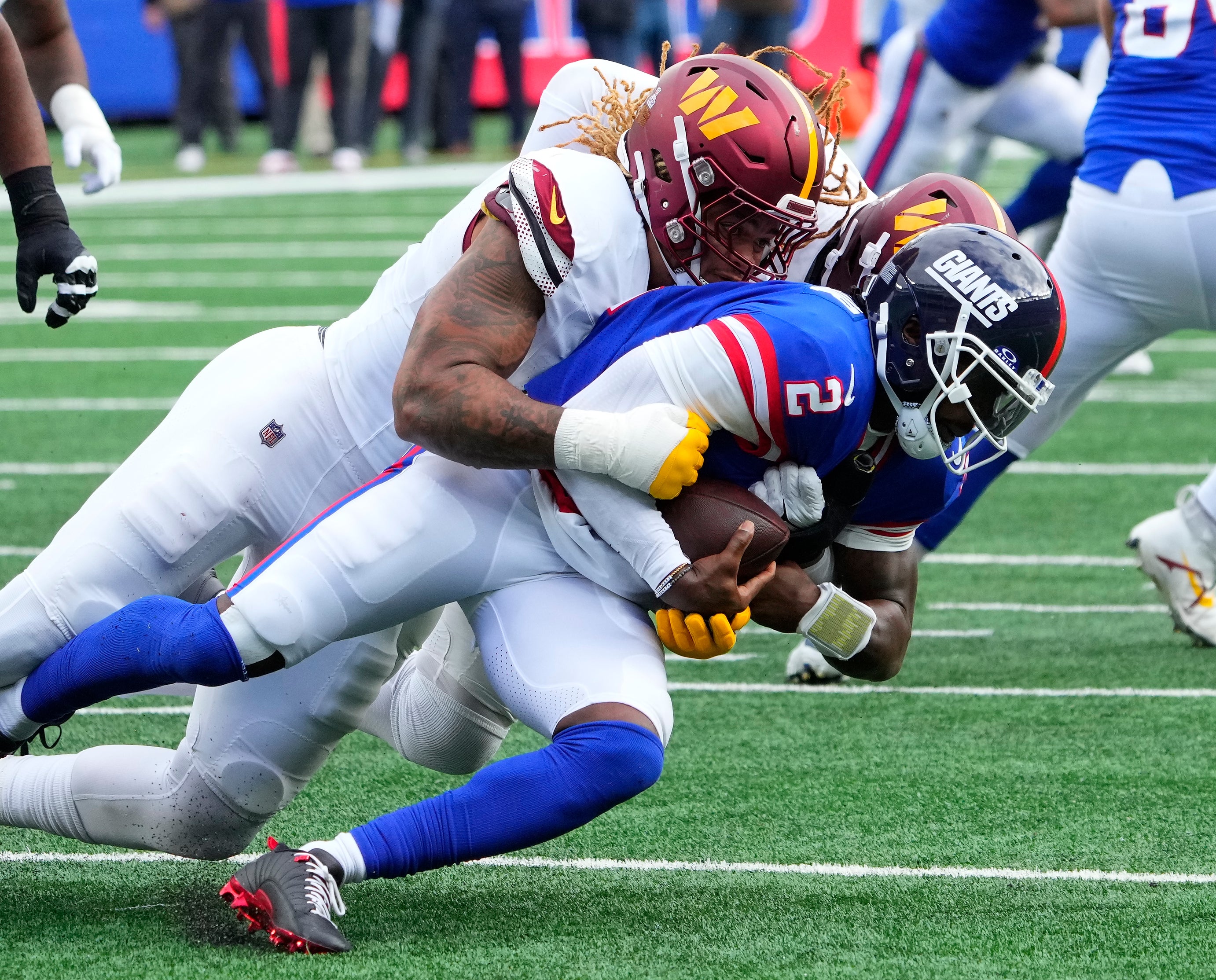 Oct 22, 2023; East Rutherford, New Jersey, USA; Washington Commanders defensive end Chase Young (99) sacks New York Giants quarterback Tyrod Taylor (2) in the second half at MetLife Stadium.