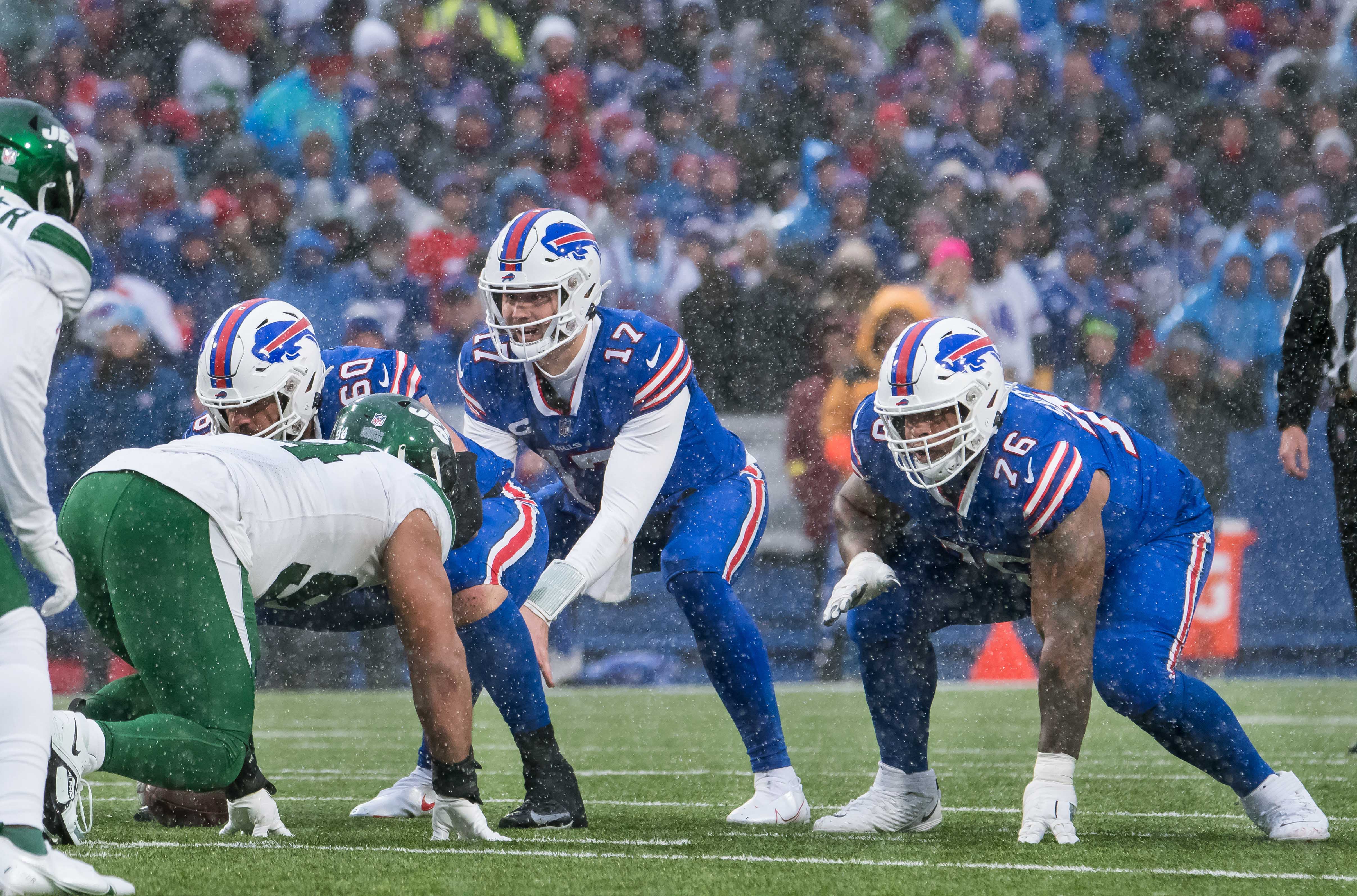 Buffalo Bills quarterback Josh Allen (17) at the line of scrimmage with center Mitch Morse (60) and guard Rodger Saffold (76) in the fourth quarter against the New York Jets at Highmark Stadium.