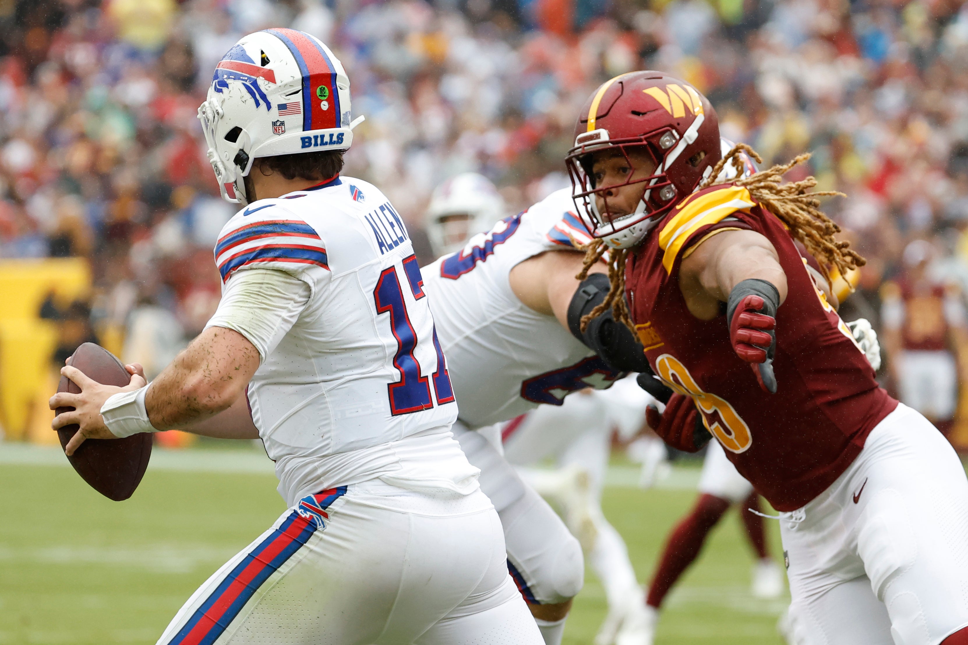 Sep 24, 2023; Landover, Maryland, USA; Buffalo Bills quarterback Josh Allen (17) scrambles from Washington Commanders defensive end Chase Young (99) at FedExField.