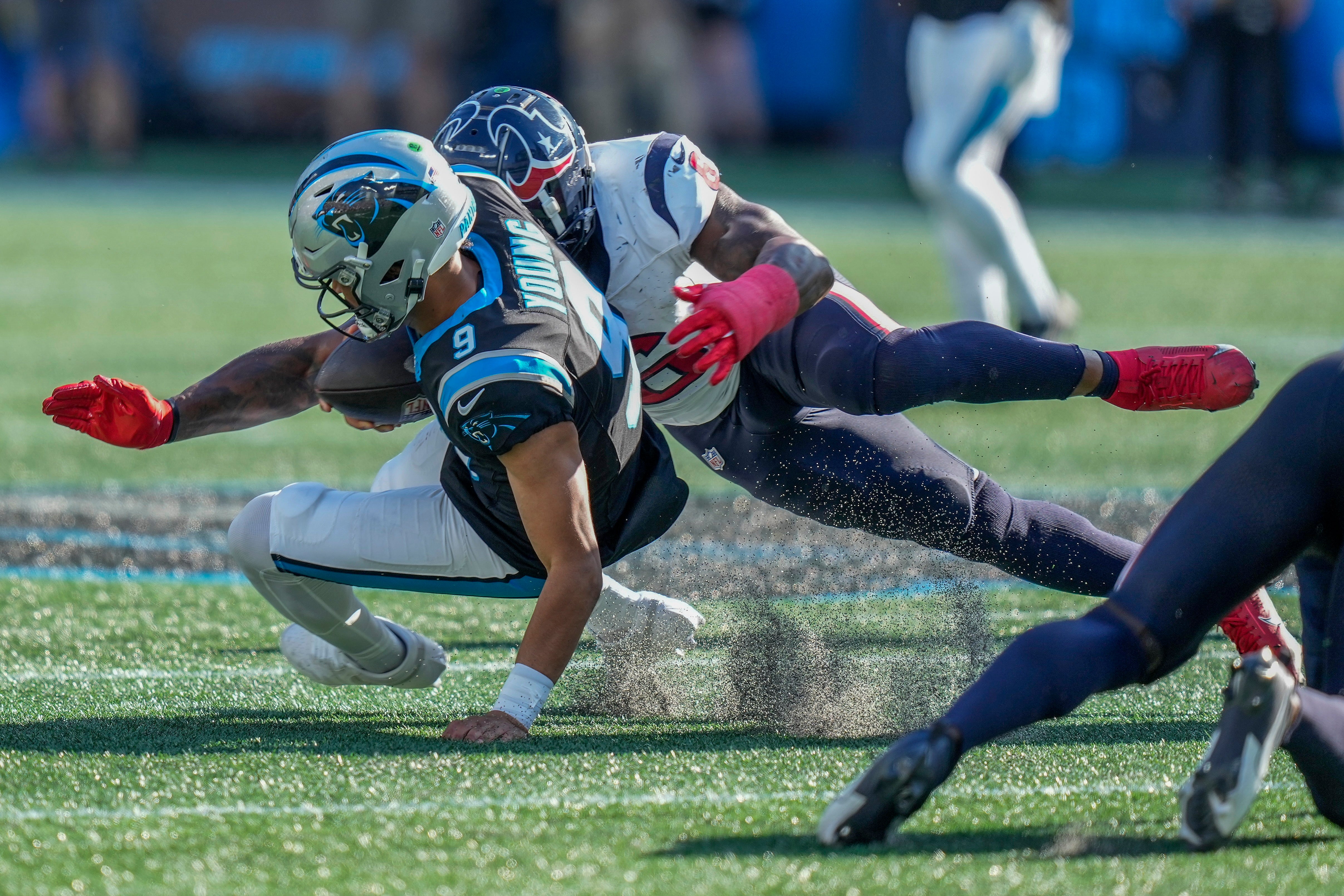 Oct 29, 2023; Charlotte, North Carolina, USA; Carolina Panthers quarterback Bryce Young (9) is tackled by Houston Texans linebacker Denzel Perryman (6) on a keeper play during the second half at Bank of America Stadium. Mandatory Credit: Jim Dedmon-USA TODAY Sports