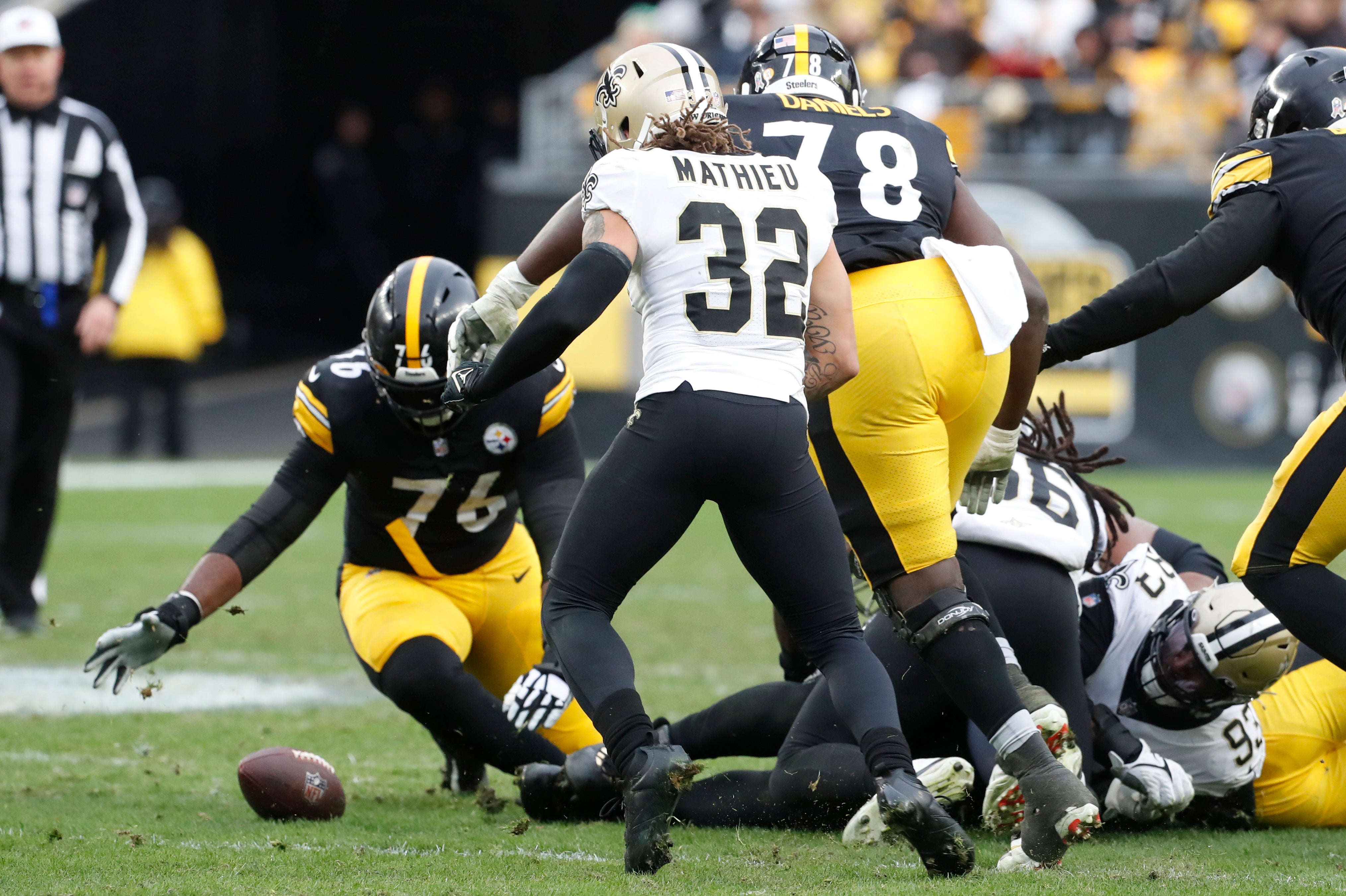 Nov 13, 2022; Pittsburgh, Pennsylvania, USA; Pittsburgh Steelers offensive tackle Chukwuma Okorafor (76) recovers a fumble to retain possession of the ball against the New Orleans Saints during the fourth quarter at Acrisure Stadium. The Steelers won 20-10. Mandatory Credit: Charles LeClaire-USA TODAY Sports  