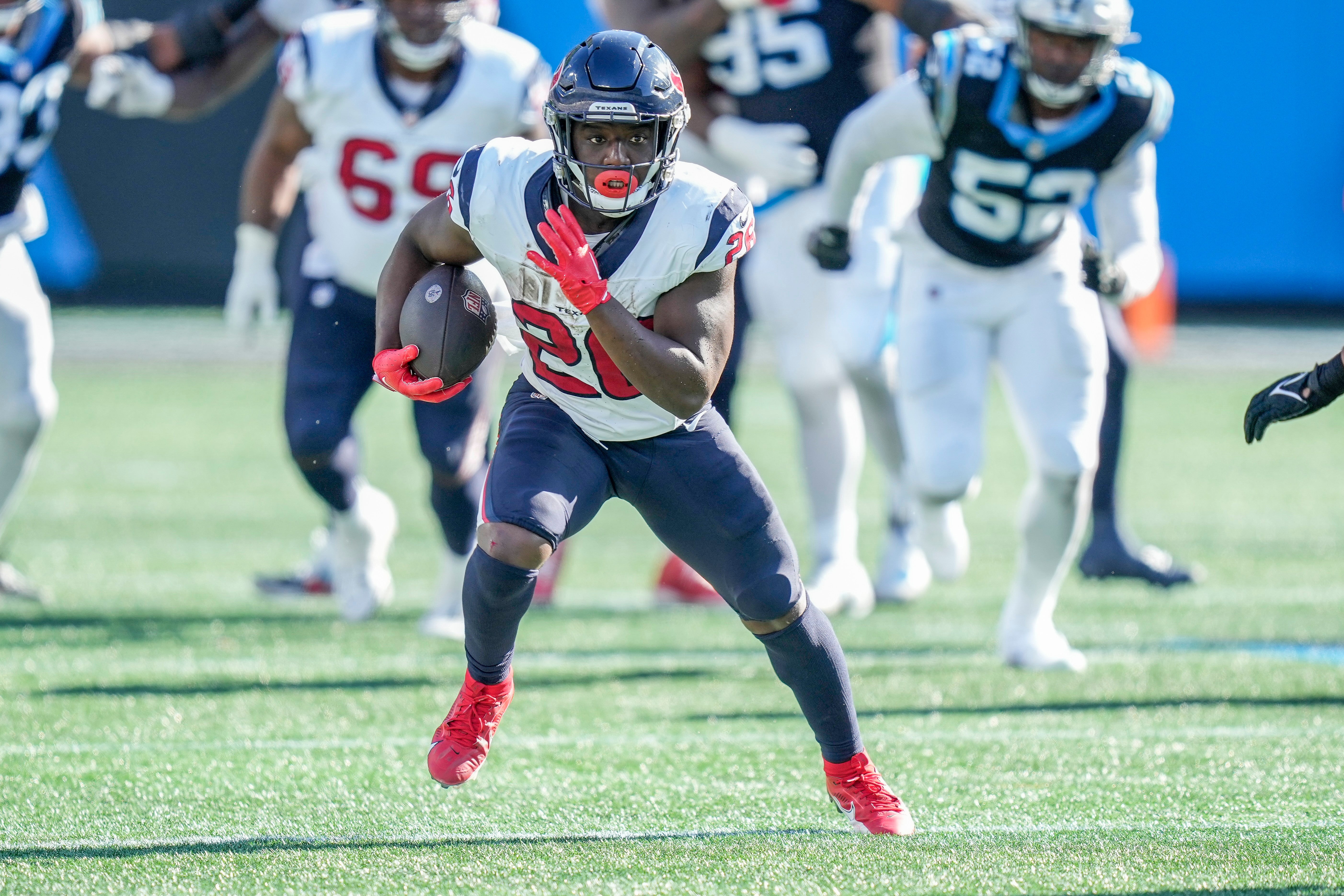 Oct 29, 2023; Charlotte, North Carolina, USA; Houston Texans running back Devin Singletary (26) runs into the secondary against the Carolina Panthers during the second half at Bank of America Stadium.