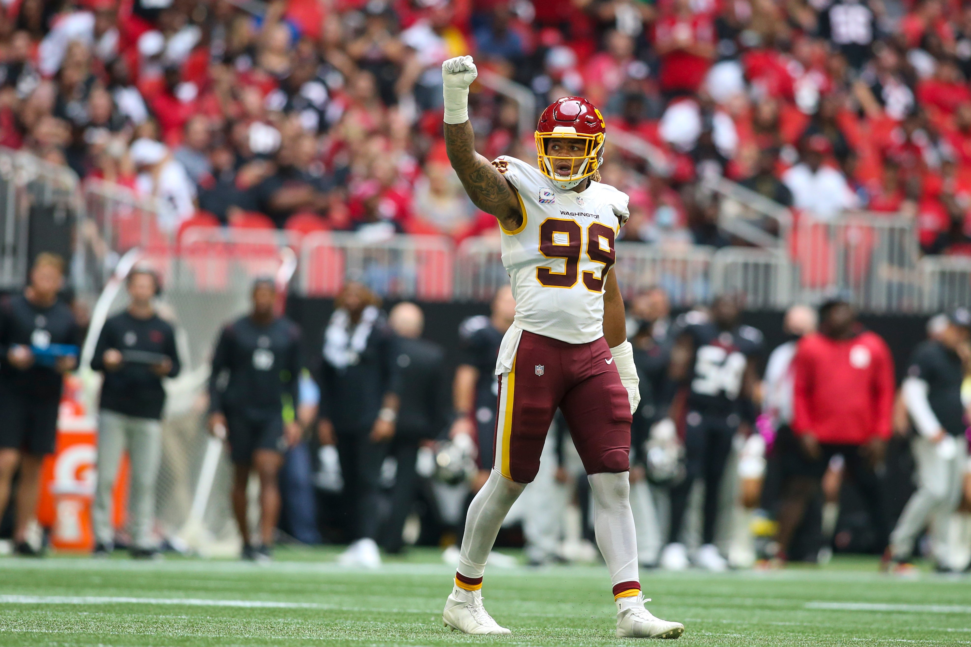 Oct 3, 2021; Atlanta, Georgia, USA; Washington Football Team Oct 3, 2021; Atlanta, Georgia, USA; Washington Football Team defensive end Chase Young (99) celebrates after a third down stop against the Atlanta Falcons in the second half at Mercedes-Benz Stadium.