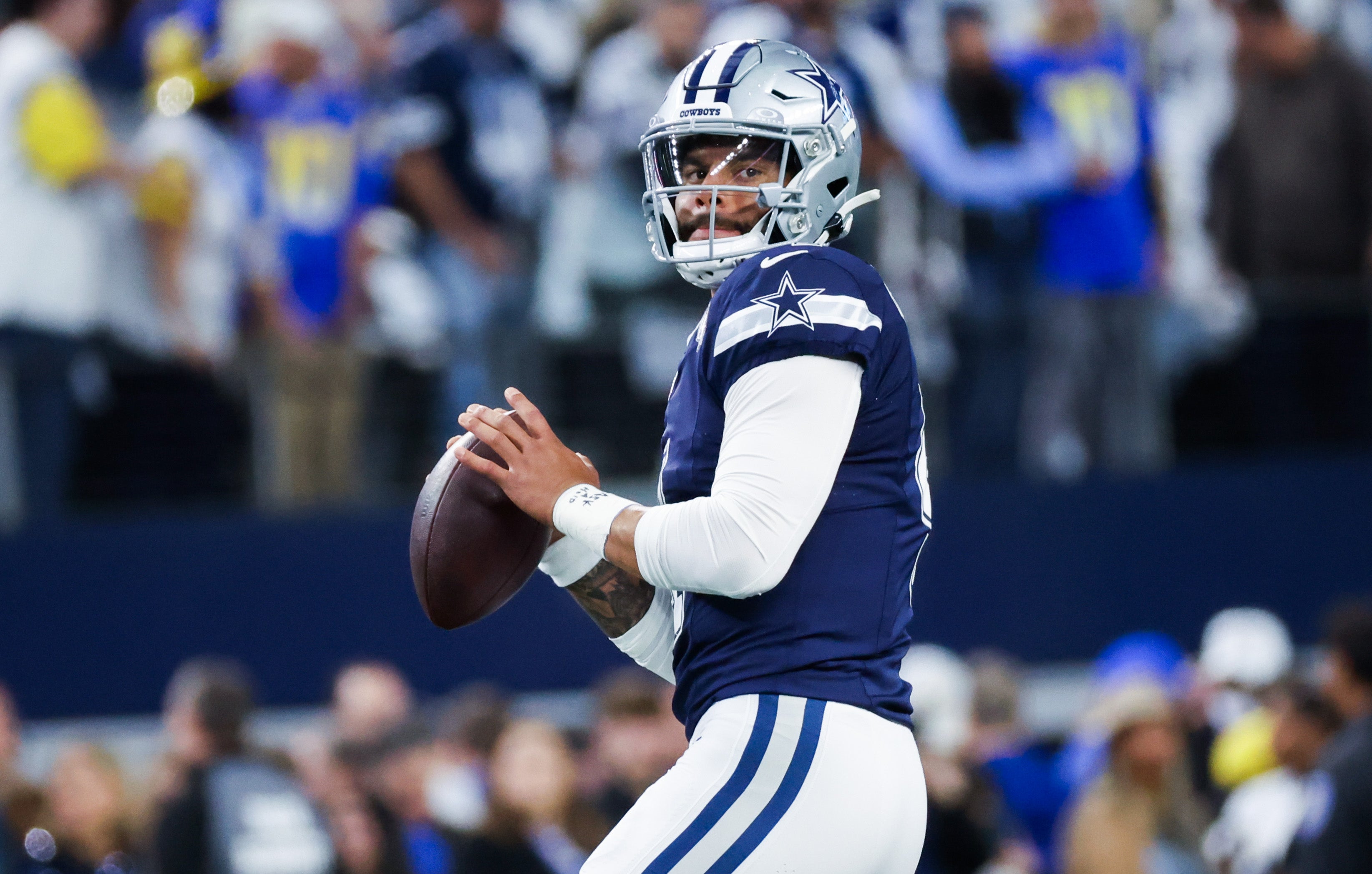 Dallas Cowboys quarterback Dak Prescott (4) warms up before the game against the Los Angeles Rams at AT&T Stadium.