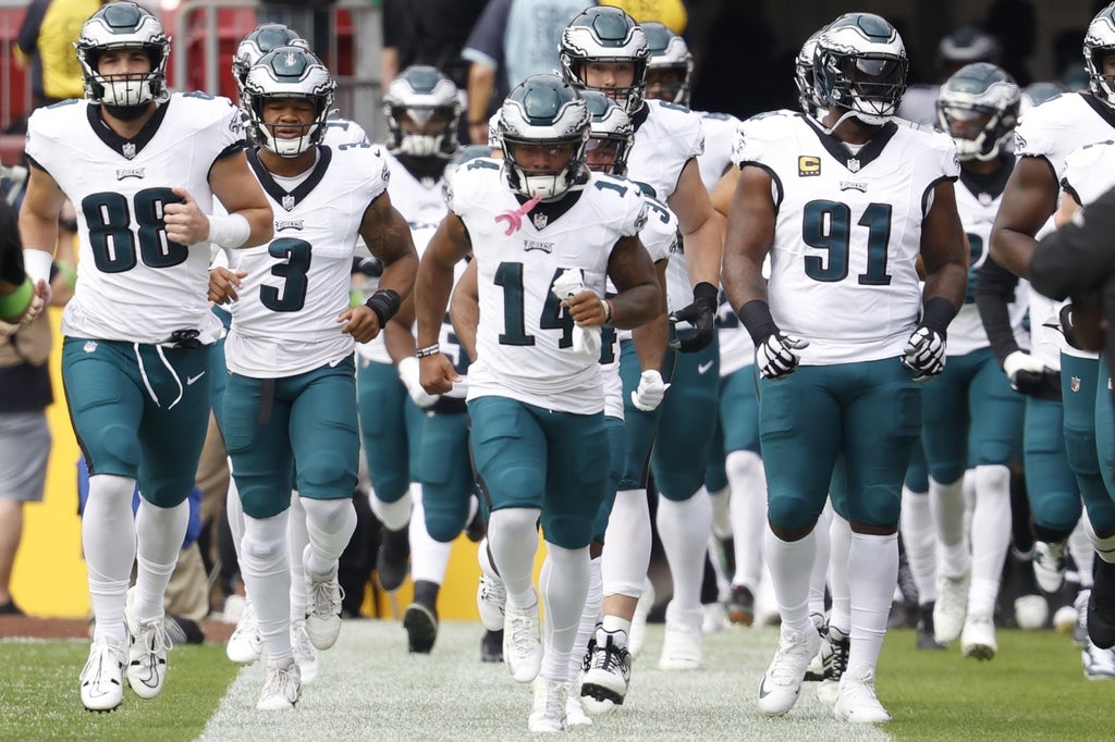 Eagles players run onto the field