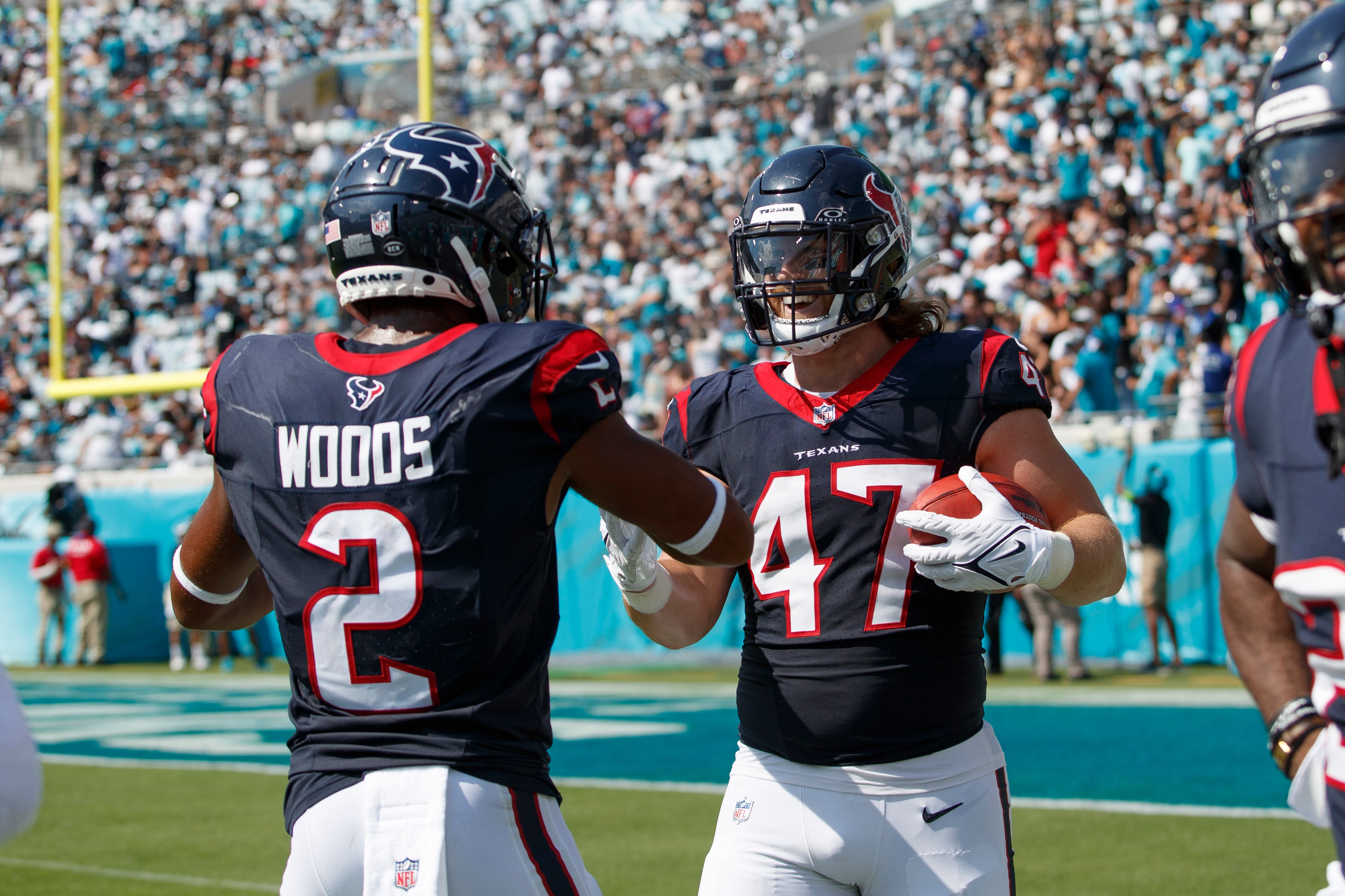 Sep 24, 2023; Jacksonville, Florida, USA; Houston Texans fullback Andrew Beck (47) celebrates a touchdown off of a return kick with wide receiver Robert Woods (2) against the Jacksonville Jaguars during the third quarter at EverBank Stadium.