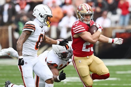 San Francisco 49ers running back Christian McCaffrey (23) runs with the ball as Cleveland Browns cornerback Greg Newsome II (0) and defensive end Myles Garrett (95) pursue during the first half at Cleveland Browns Stadium