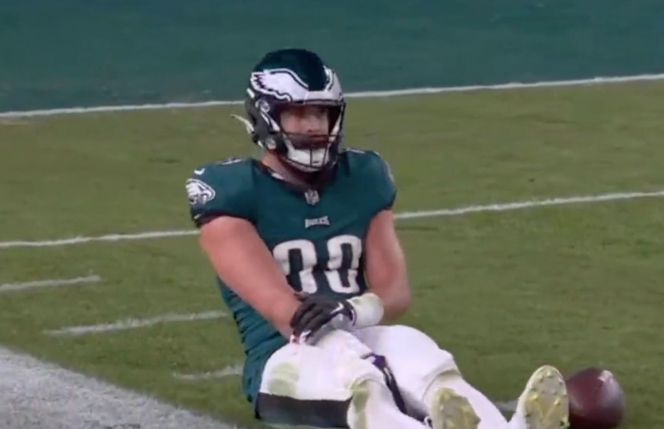 Eagles tight end Dallas Goedert holds his right arm.