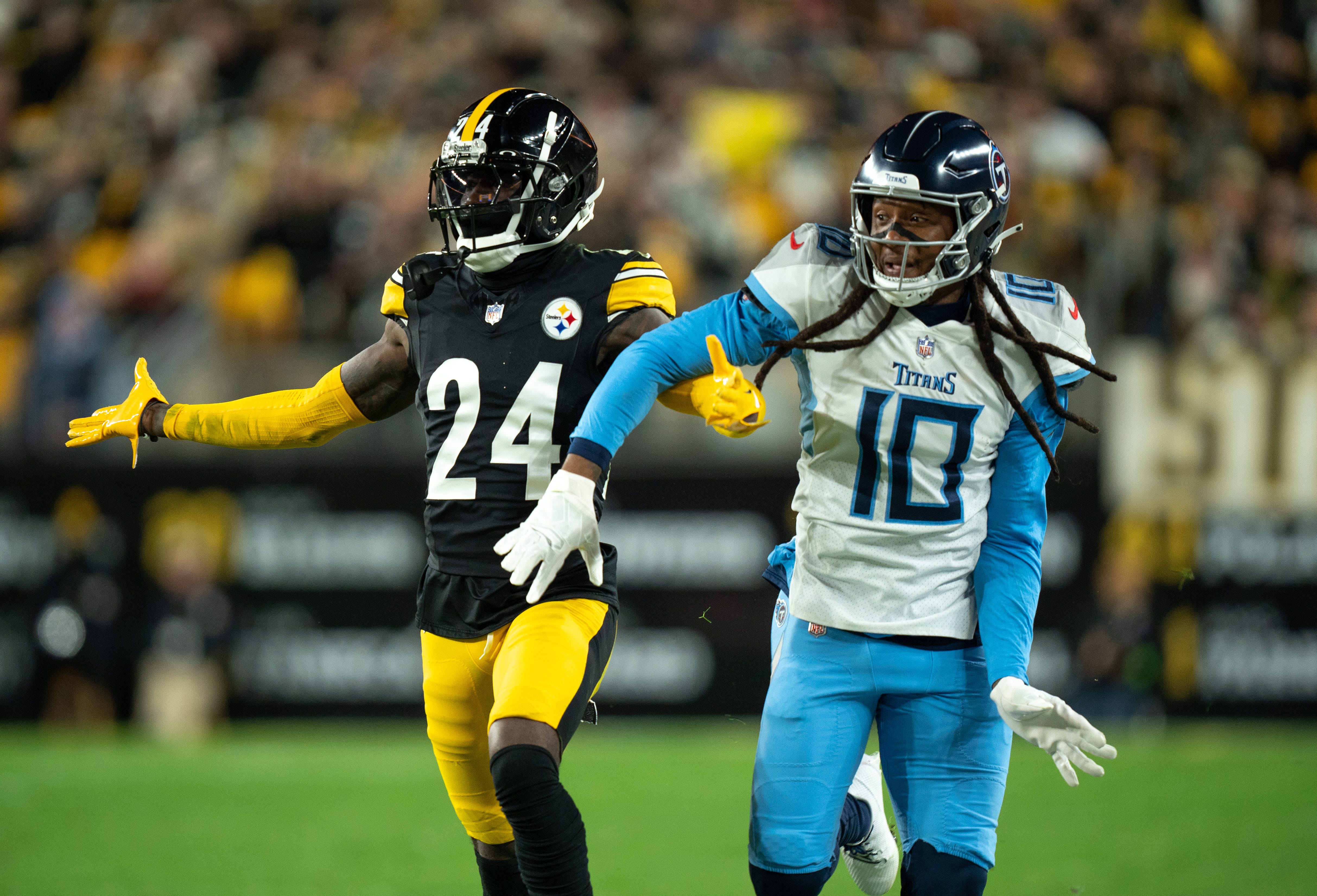 Pittsburgh Steelers cornerback Joey Porter Jr. (24) and Tennessee Titans wide receiver DeAndre Hopkins (10) get tangled up during their game at Acrisure Stadium in Pittsburgh, Penn., Thursday, Nov. 2, 2023.