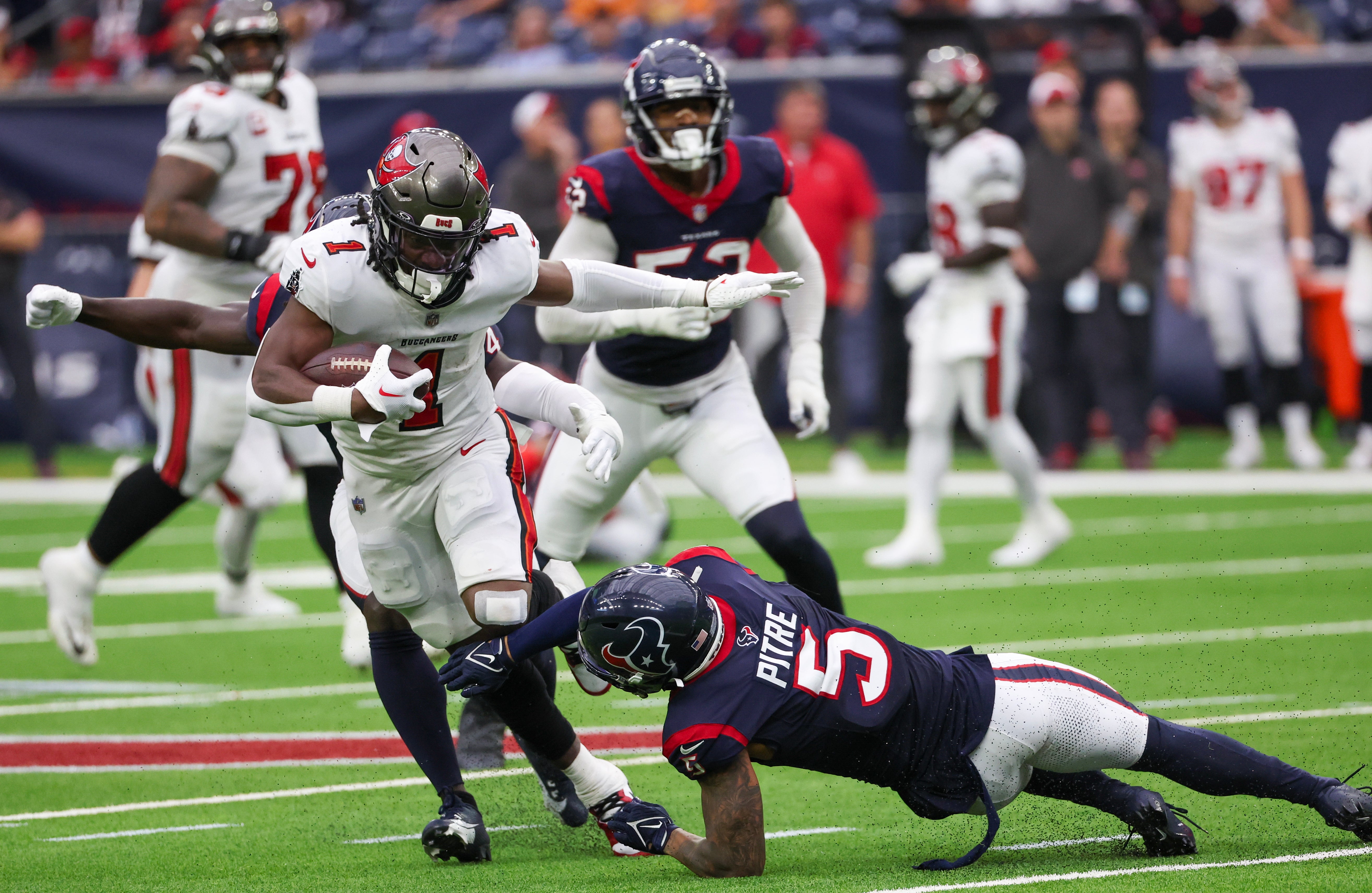 Nov 5, 2023; Houston, Texas, USA; Tampa Bay Buccaneers running back Rachaad White (1) breaks the tackle of Houston Texans safety Jalen Pitre (5) in the fourth quarter at NRG Stadium. Mandatory Credit: Thomas Shea-USA TODAY Sports