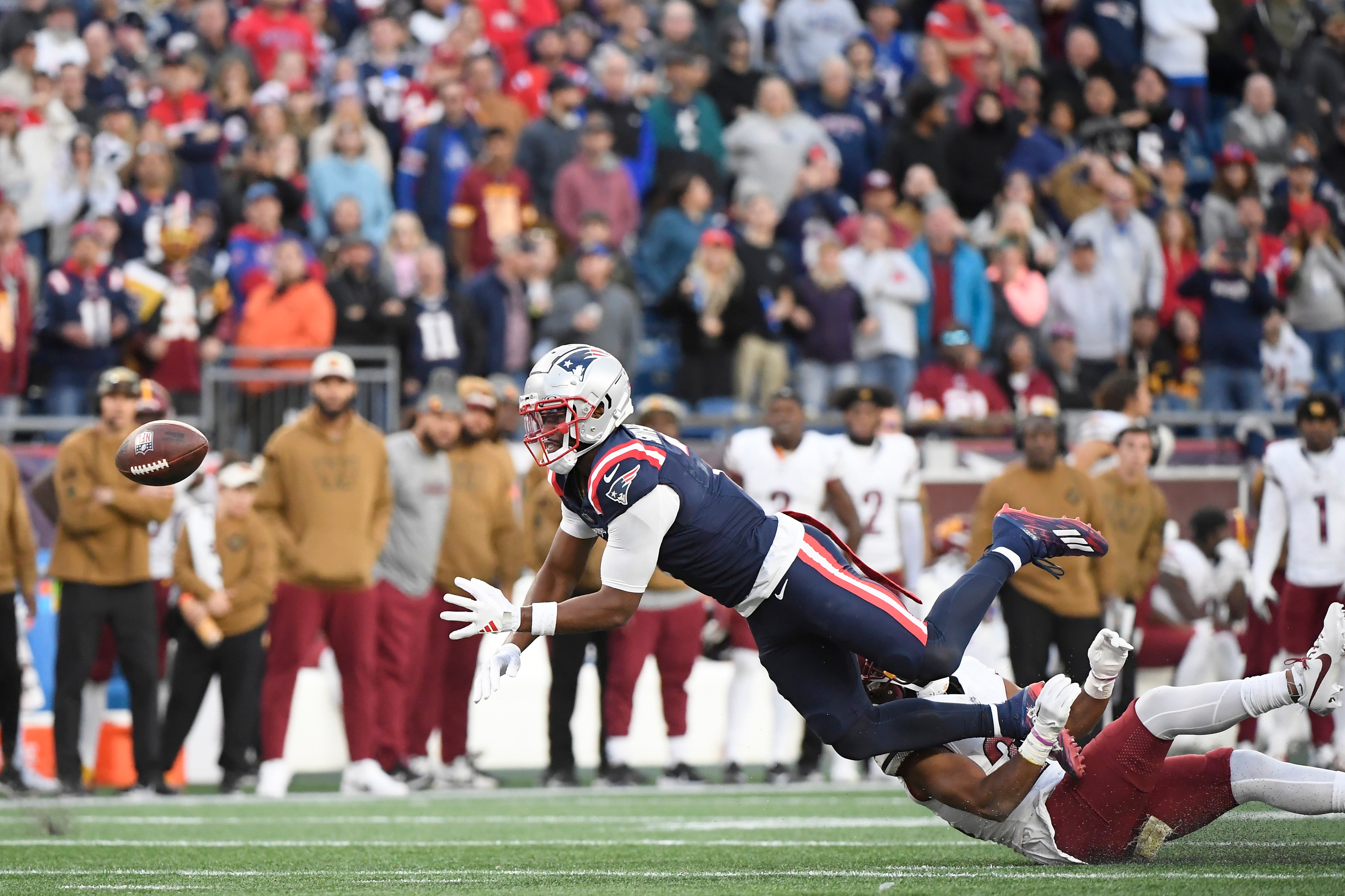 New England Patriots wide receiver JuJu Smith-Schuster watches the ball as it slips out of his hands during the second half against the Washington Commanders