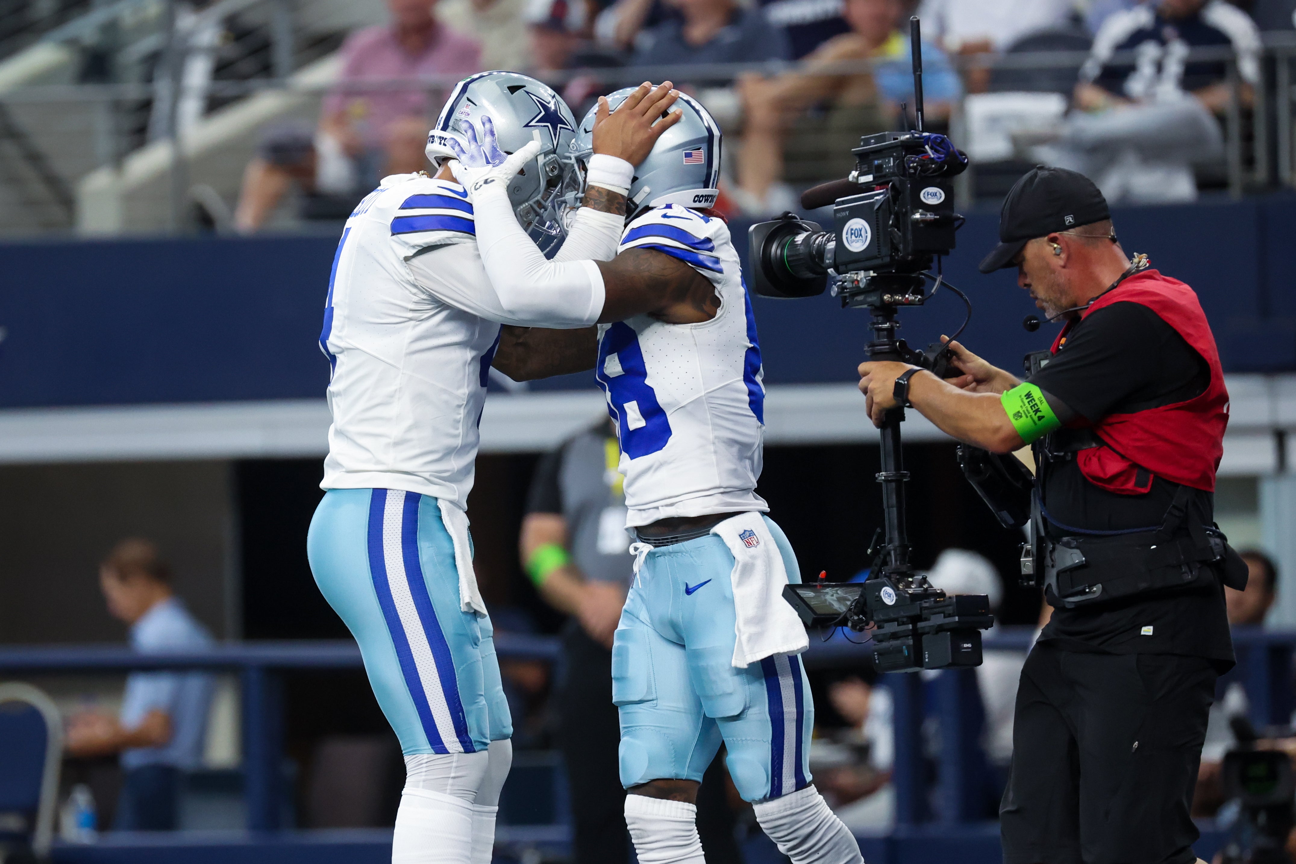 Dallas Cowboys quarterback Dak Prescott (4) celebrates with Dallas Cowboys wide receiver CeeDee Lamb (88) after throwing a touchdown pass during the first quarter against the New England Patriots at AT&T Stadium.