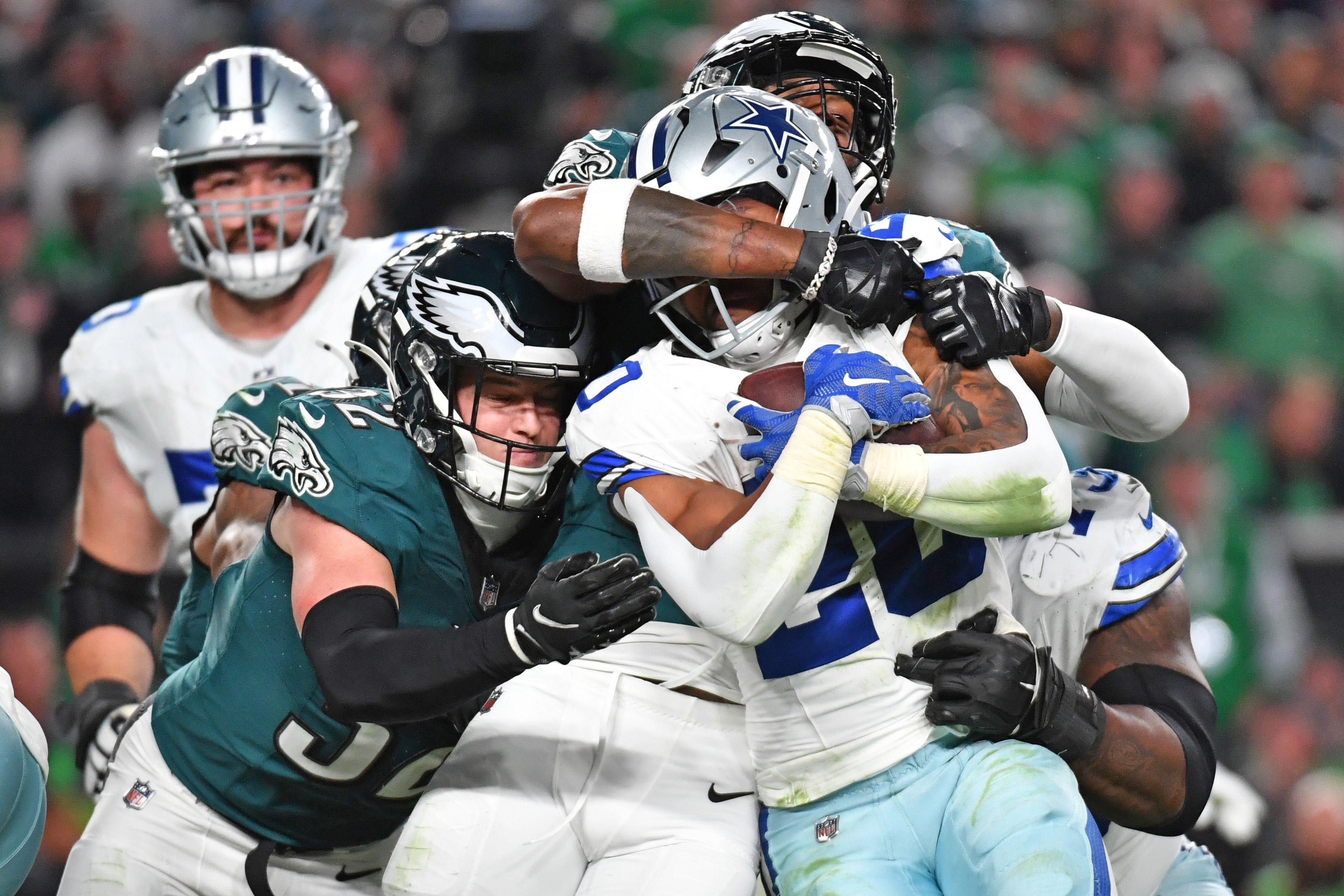 Dallas Cowboys running back Tony Pollard (20) is stopped by Philadelphia Eagles linebacker Zach Cunningham (52) and safety Reed Blankenship (32) at Lincoln Financial Field.
