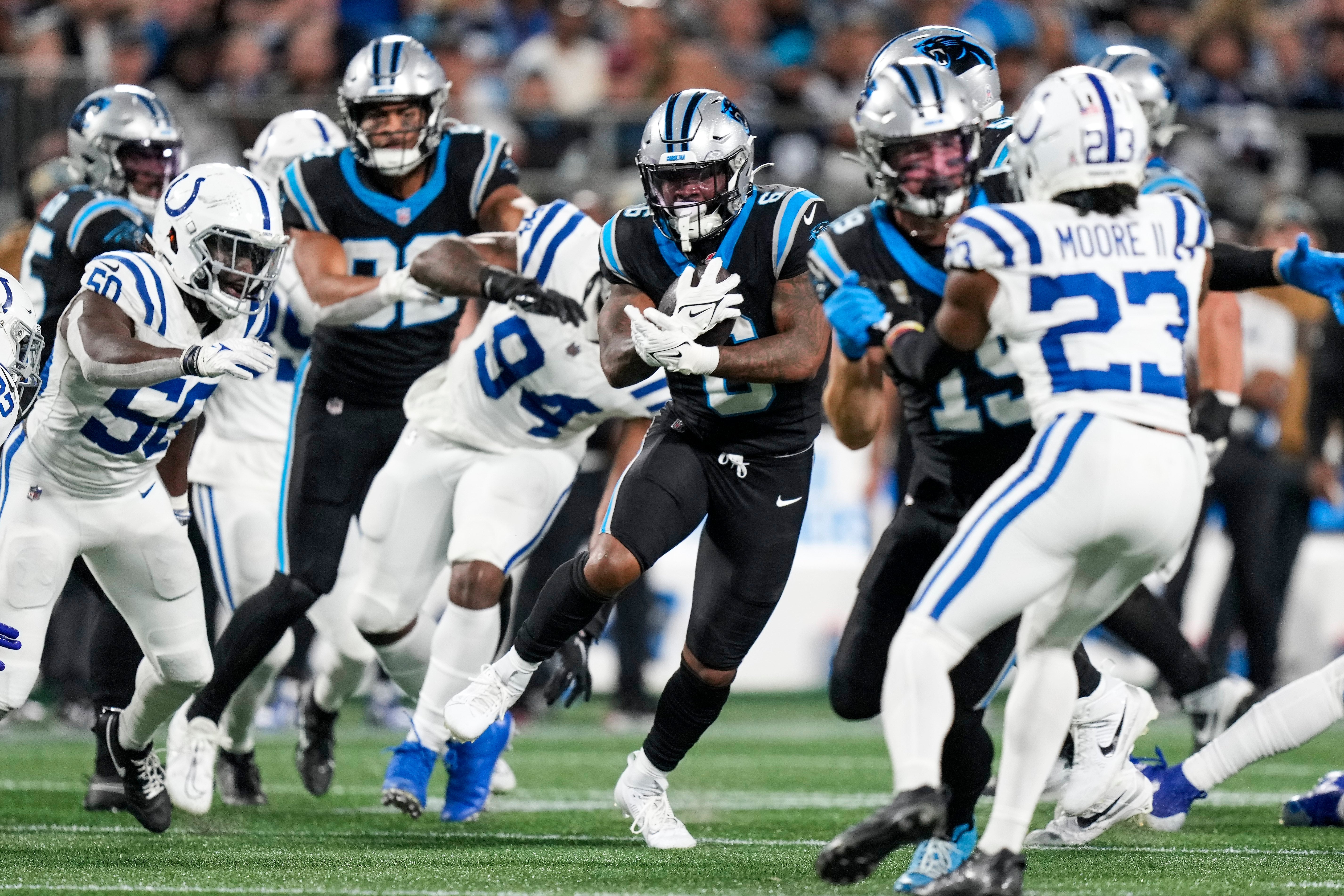 Nov 5, 2023; Charlotte, North Carolina, USA; Carolina Panthers running back Miles Sanders (6) runs behind blockers against the Indianapolis Colts during the second half at Bank of America Stadium. Mandatory Credit: Jim Dedmon-USA TODAY Sports