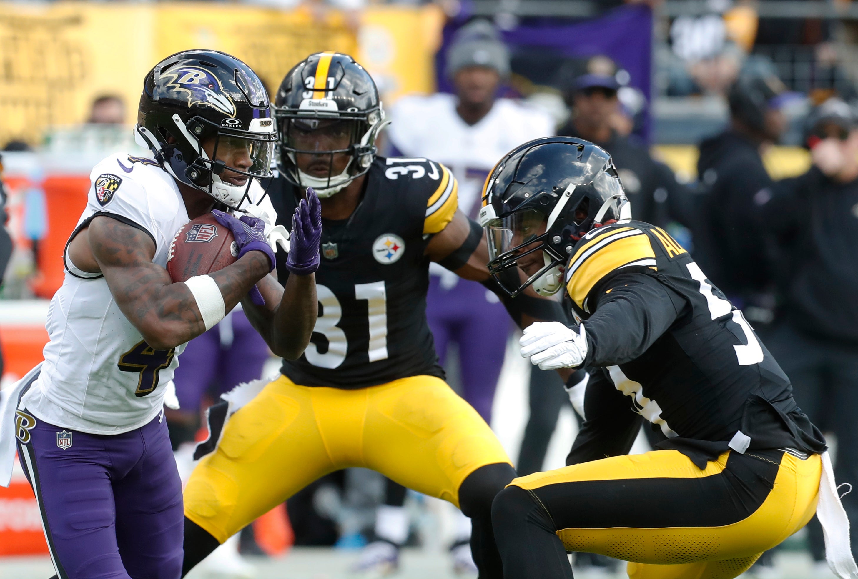 Oct 8, 2023; Pittsburgh, Pennsylvania, USA; Baltimore Ravens wide receiver Zay Flowers (4) runs after a catch as Pittsburgh Steelers safety Keanu Neal (31) and linebacker Kwon Alexander (54) defend during the first quarter at Acrisure Stadium. Mandatory Credit: Charles LeClaire-USA TODAY Sports