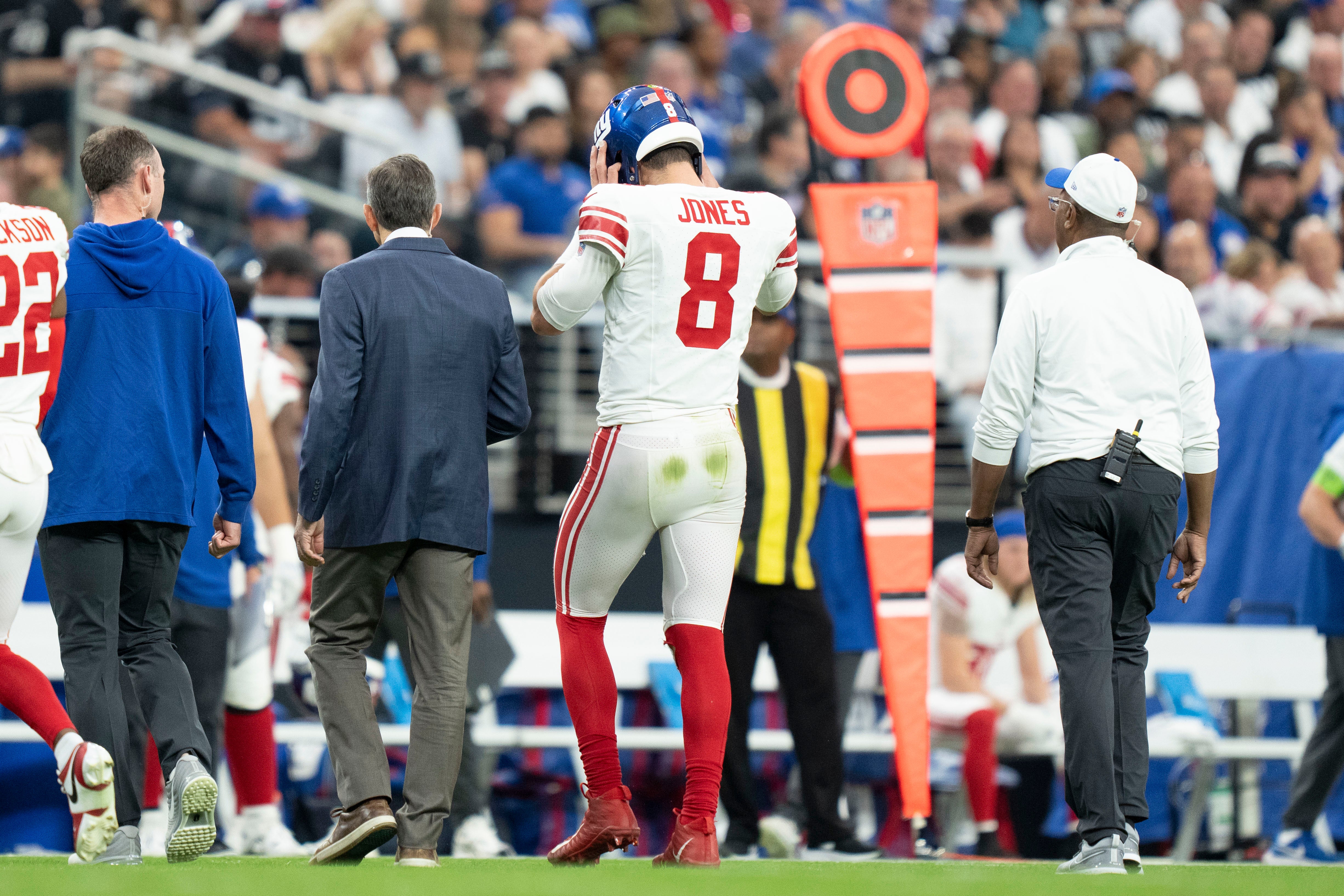 New York Giants quarterback Daniel Jones walks to the sideline after an injury against the Las Vegas Raiders during the second quarter at Allegiant Stadium.