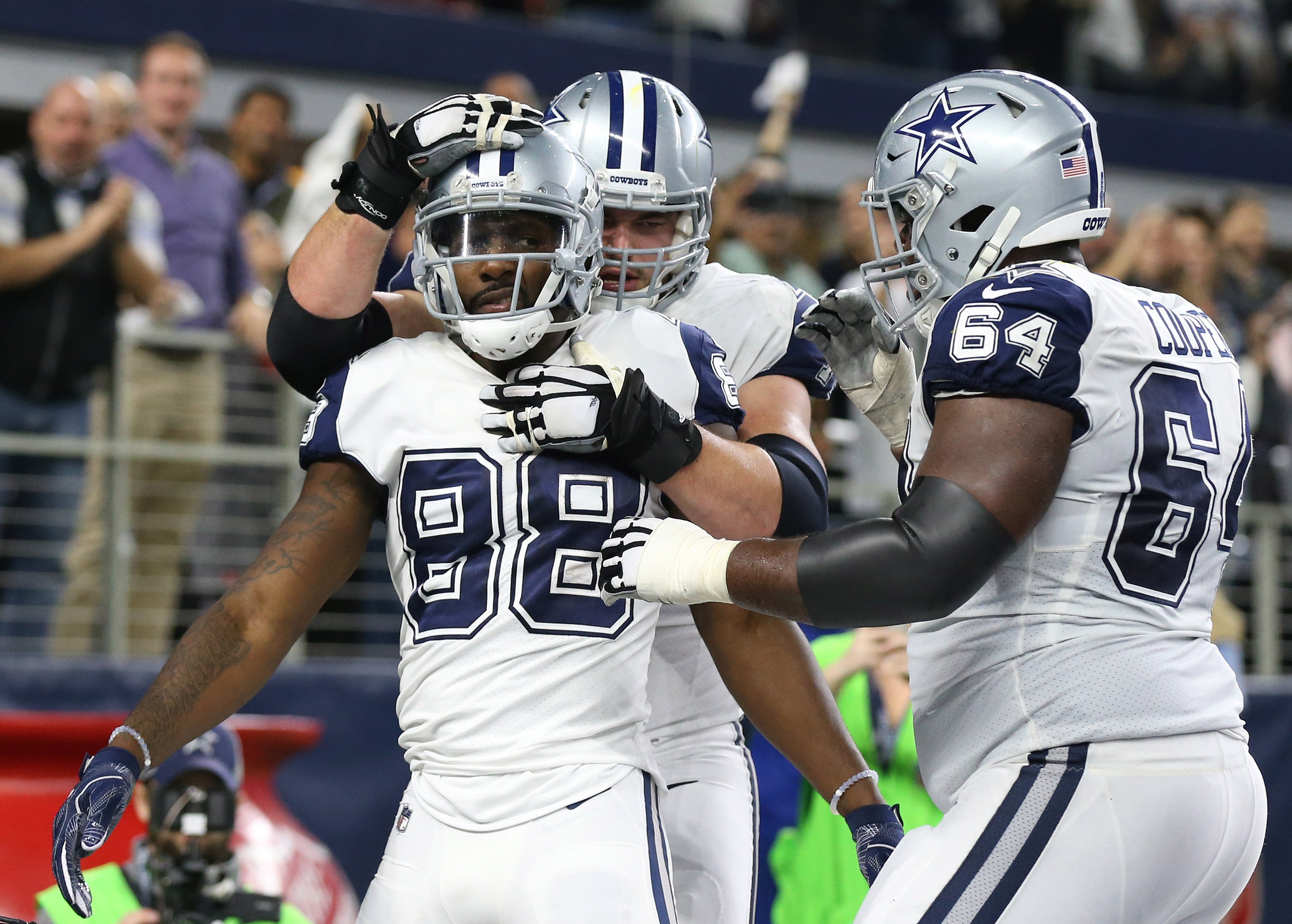 Dallas Cowboys wide receiver Dez Bryant (88) celebrates his fourth-quarter touchdown with teammates including guard Jonathan Cooper (64) against the Washington Redskins at AT&T Stadium.