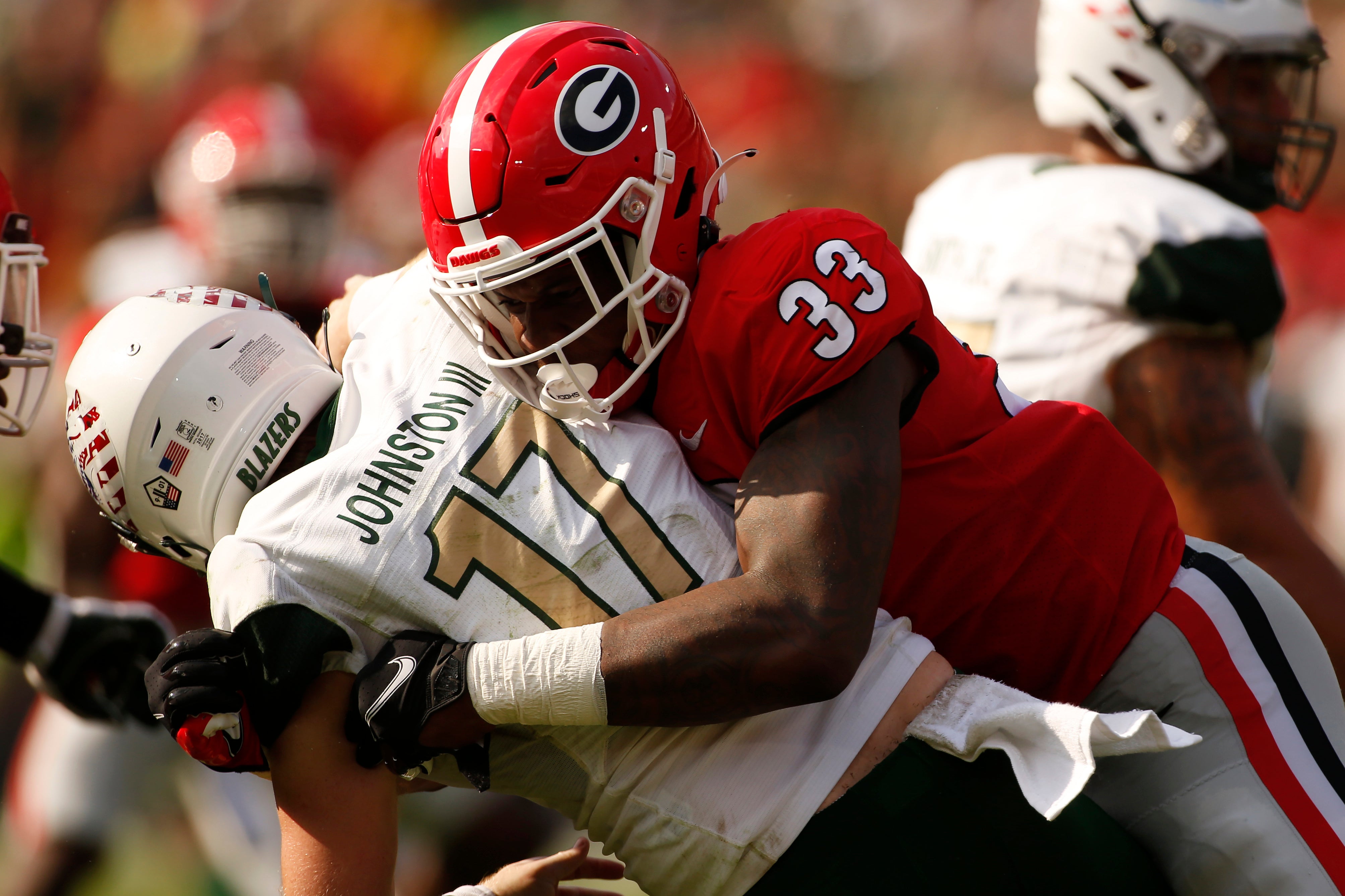Sep 11, 2021; Athens, Georgia, USA; Georgia Bulldogs outside linebacker Robert Beal Jr. (33) sacks UAB Blazers quarterback Tyler Johnston III (17) during the first half at Sanford Stadium.