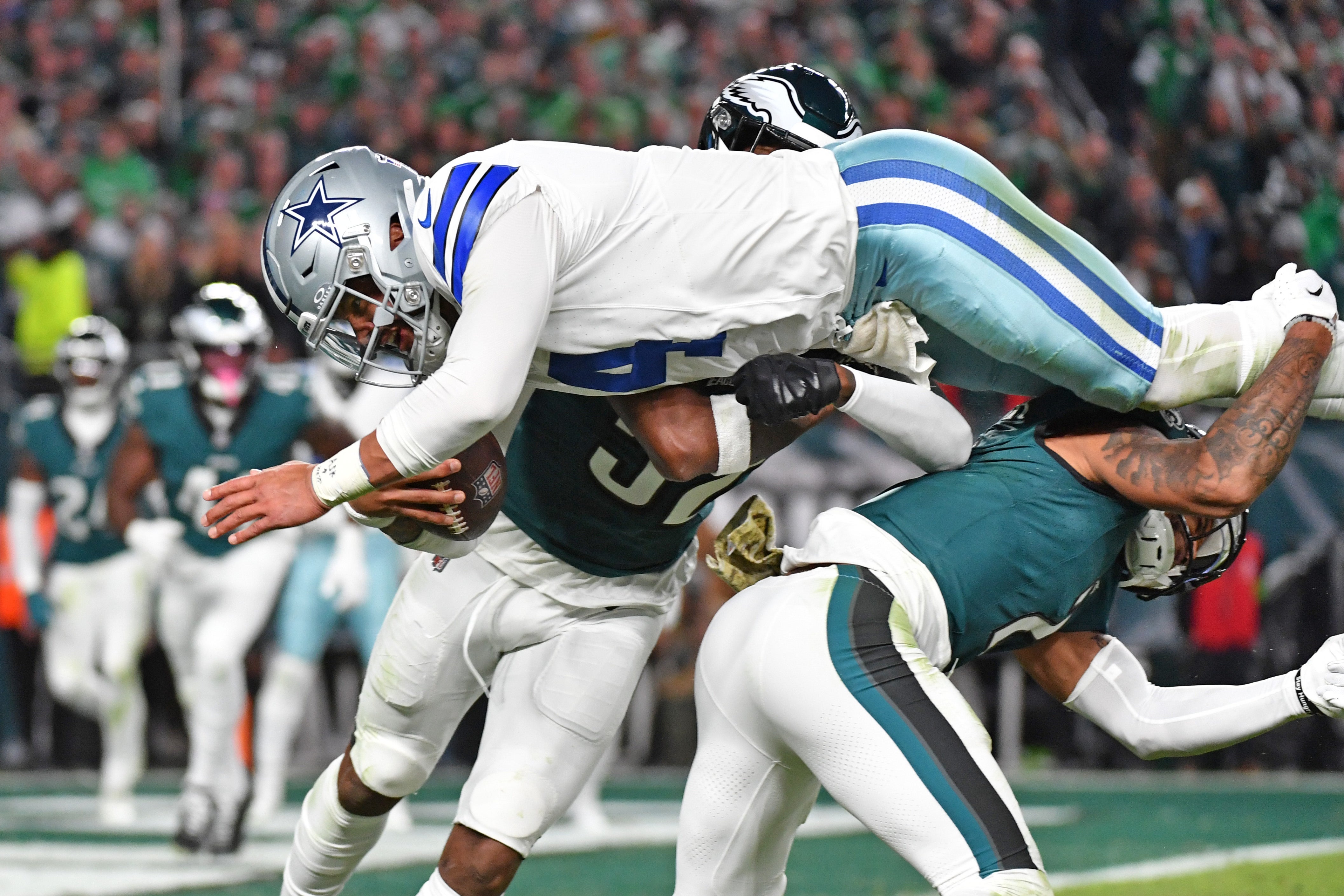 Dallas Cowboys quarterback Dak Prescott (4) is upended by Philadelphia Eagles linebacker Zach Cunningham (52) and cornerback Darius Slay (2) during the fourth quarter at Lincoln Financial Field.