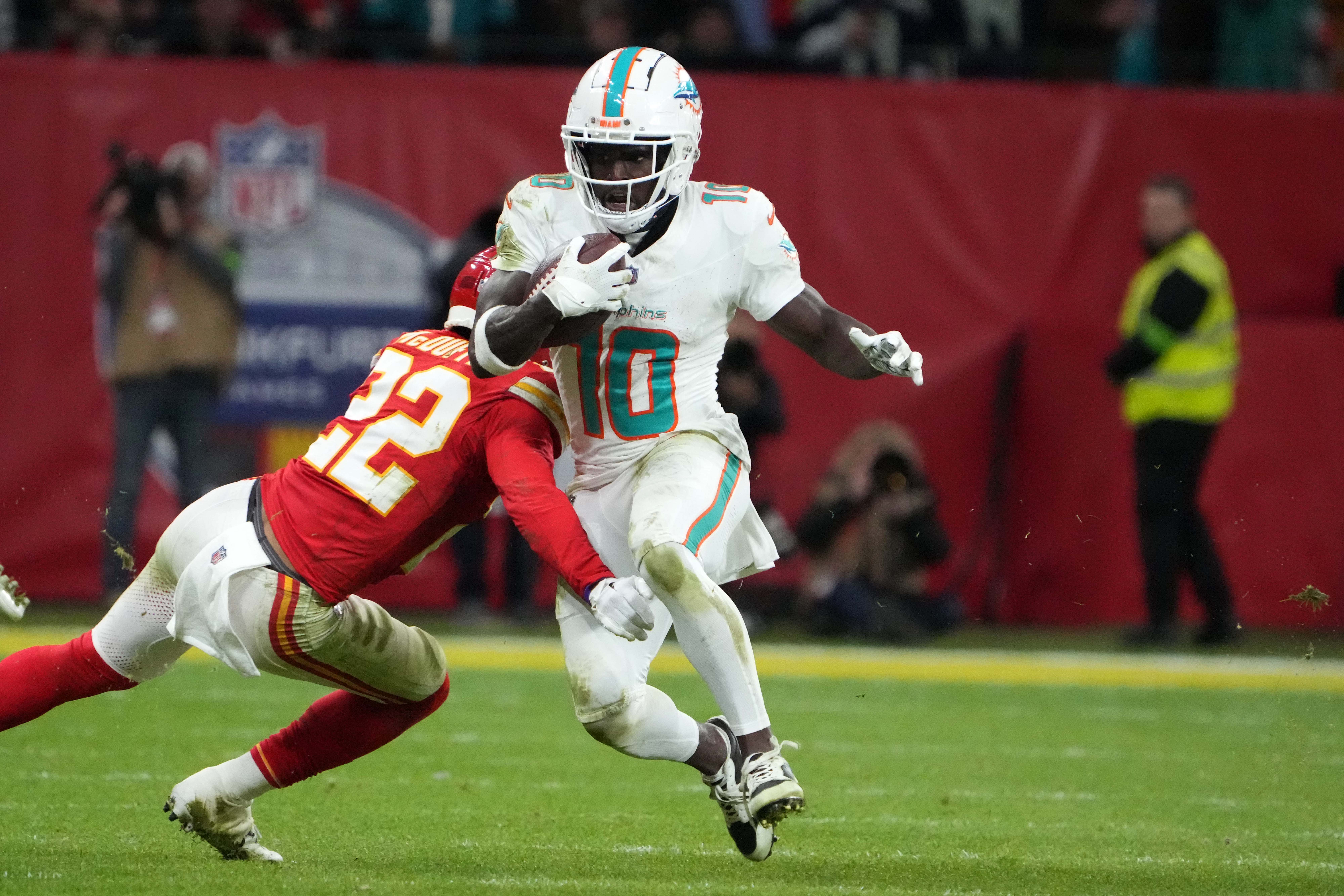 Miami Dolphins wide receiver Tyreek Hill (10) carries the ball against Kansas City Chiefs cornerback Trent McDuffie (22) during an NFL International Series game at Deutsche Bank Park.