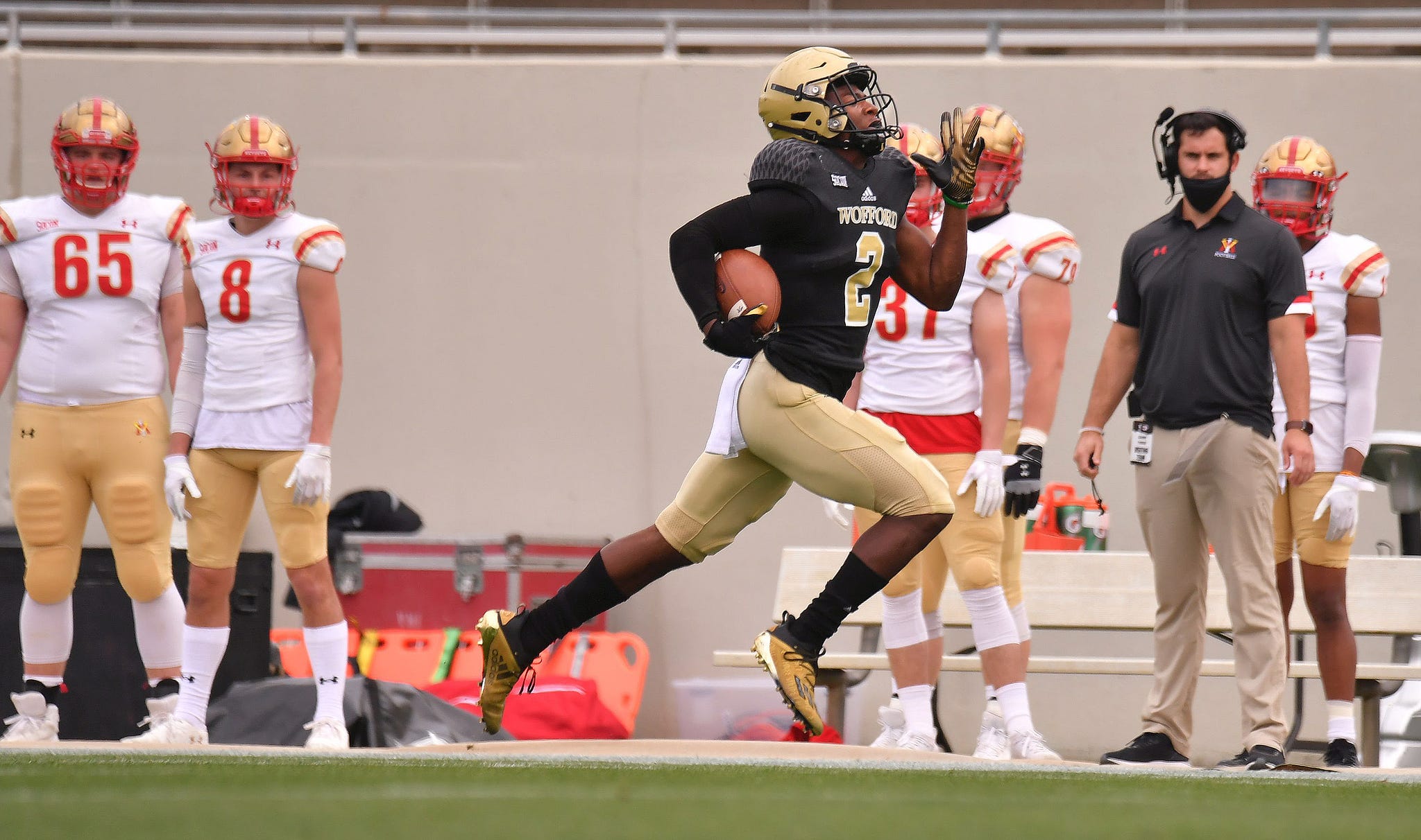 Wofford wide receiver T.J. Luther runs the ball across the field for a touchdown in the first minute of the game.