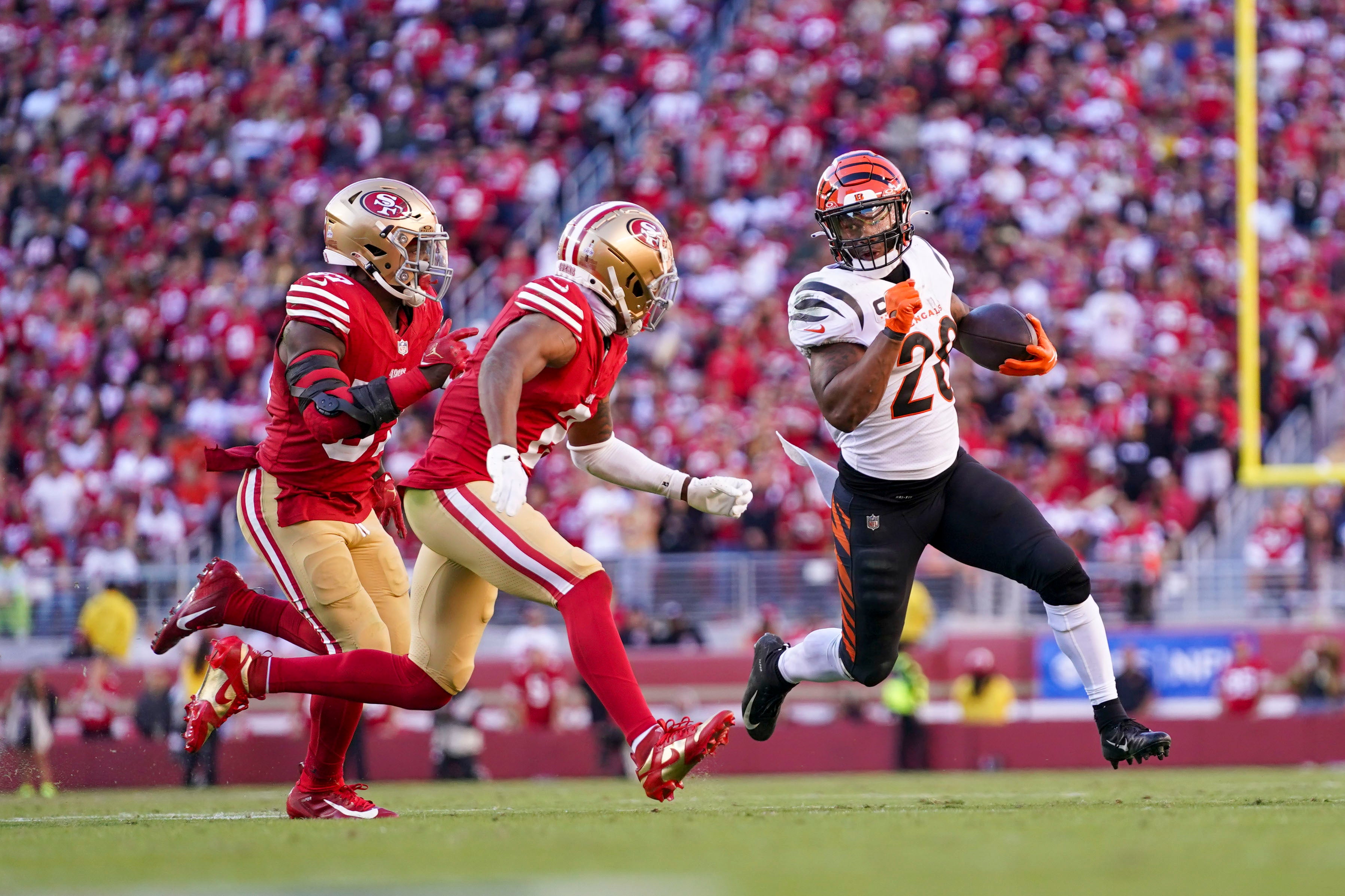 October 29, 2023; Santa Clara, California, USA; Cincinnati Bengals running back Joe Mixon (28) runs against San Francisco 49ers linebacker Dre Greenlaw (57) and cornerback Deommodore Lenoir (2) during the fourth quarter at Levi's Stadium.