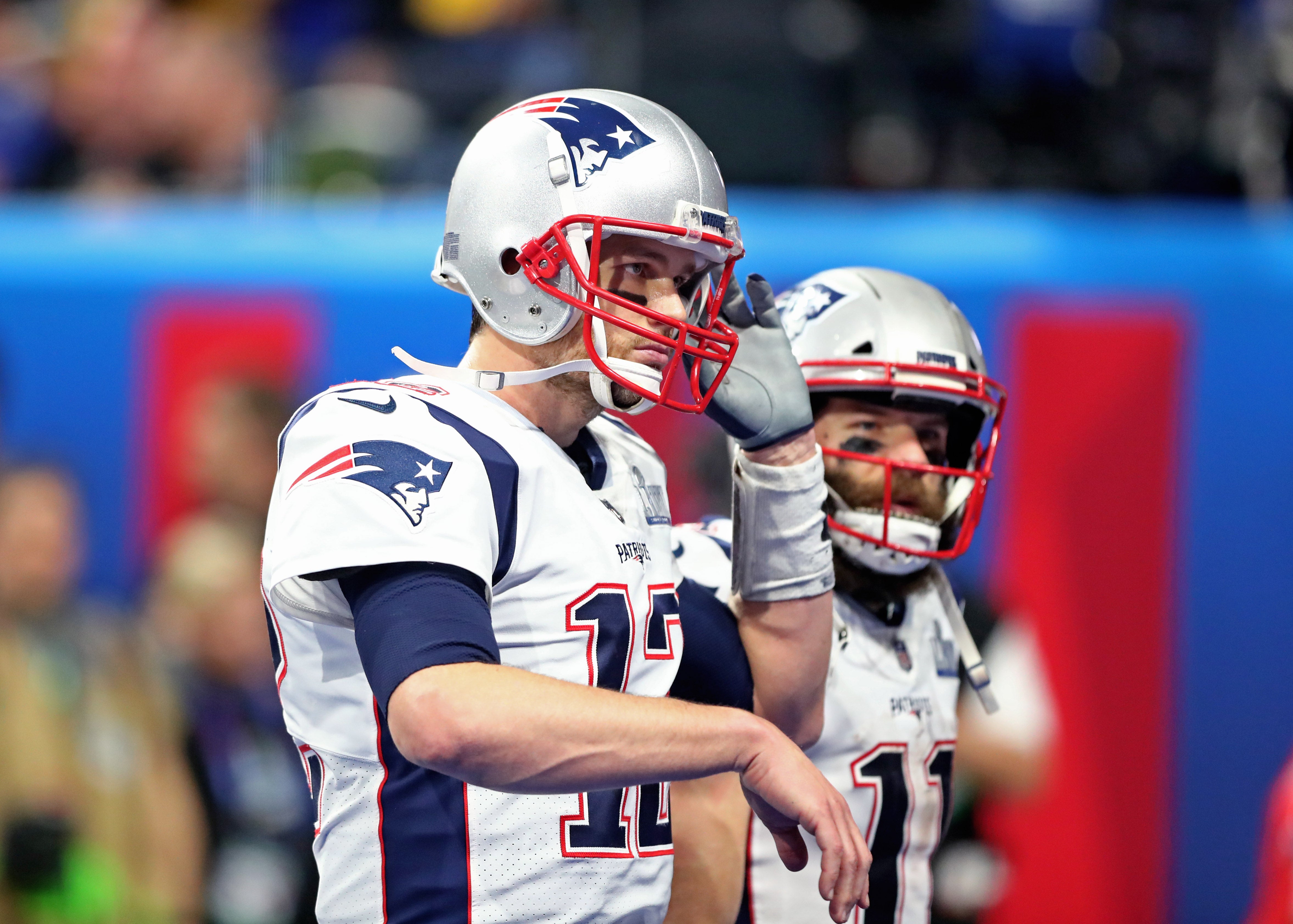 New England Patriots quarterback Tom Brady reacts alongside wide receiver Julian Edelman