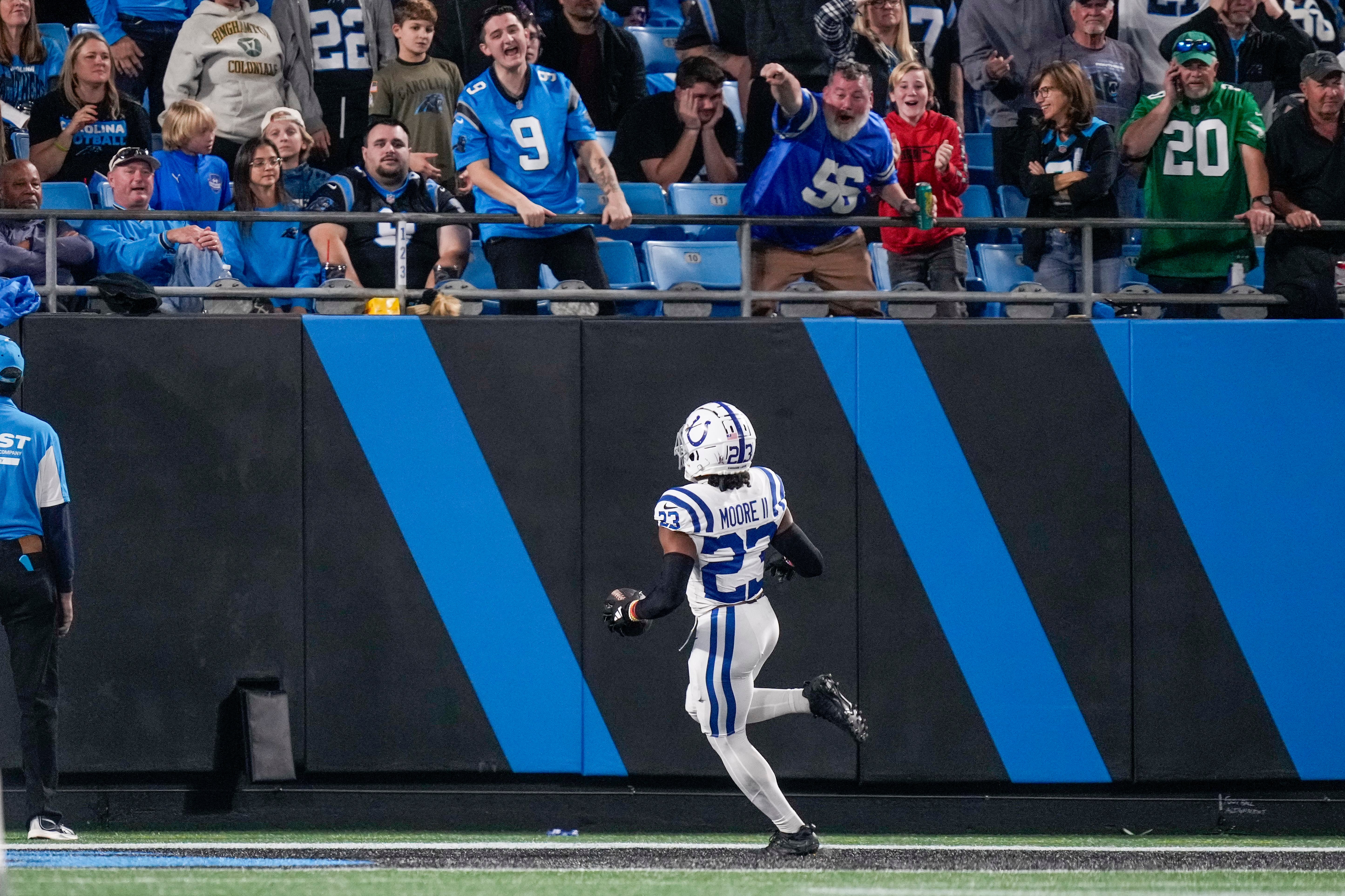 Nov 5, 2023; Charlotte, North Carolina, USA; Indianapolis Colts cornerback Kenny Moore II (23) scores on a pick six as fans cheer during the second half against the Carolina Panthers at Bank of America Stadium.