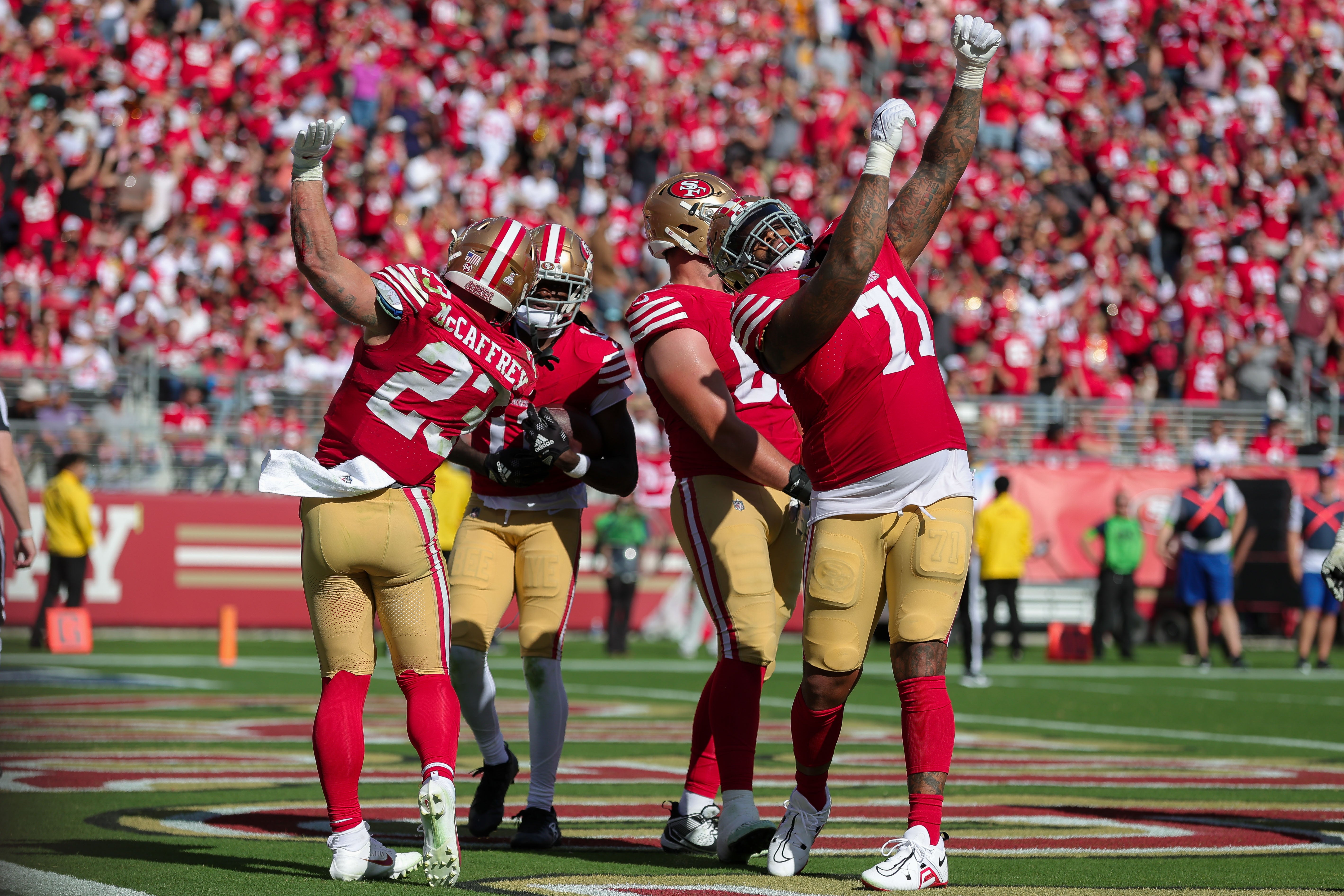 Oct 1, 2023; Santa Clara, California, USA; San Francisco 49ers running back Christian McCaffrey (23) and offensive tackle Trent Williams (71) celebrate after a touchdown during the fourth quarter against the Arizona Cardinals at Levi's Stadium.