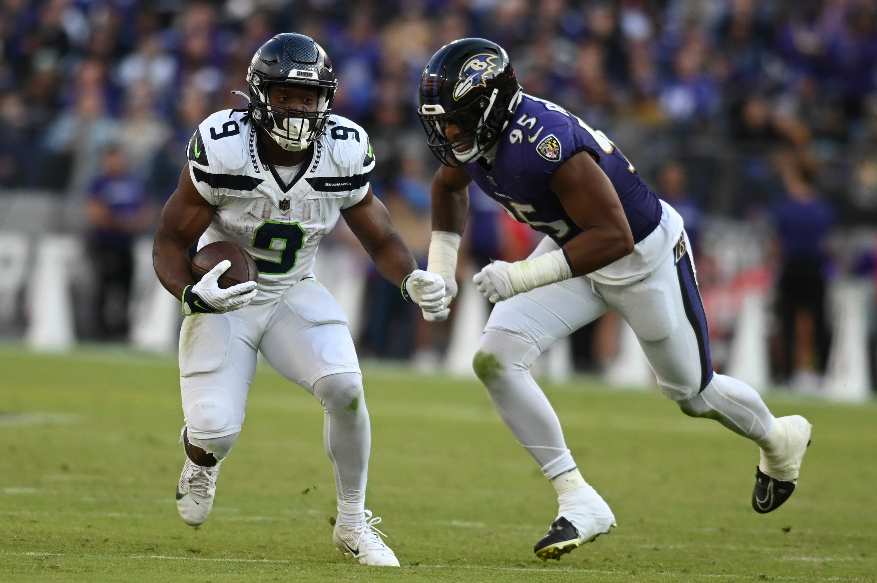 Nov 5, 2023; Baltimore, Maryland, USA; Seattle Seahawks running back Kenneth Walker III (9) rushes as Baltimore Ravens linebacker Tavius Robinson (95) chases from behind during the second half at M&T Bank Stadium. Mandatory Credit: Tommy Gilligan-USA TODAY Sports