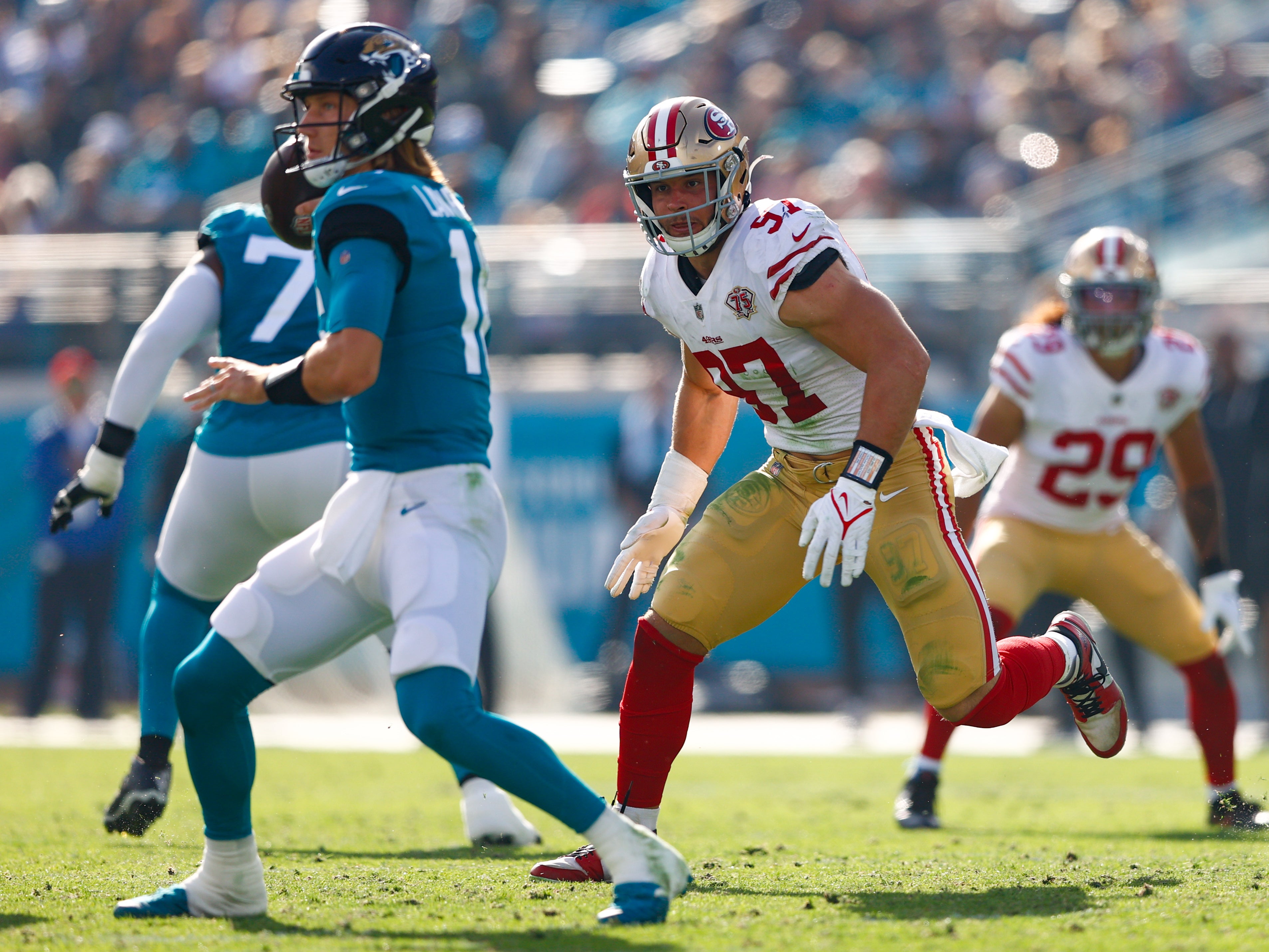 Nov 21, 2021; Jacksonville, Florida, USA; San Francisco 49ers defensive end Nick Bosa (97) pressures Jacksonville Jaguars quarterback Trevor Lawrence (16) in the second half at TIAA Bank Field.