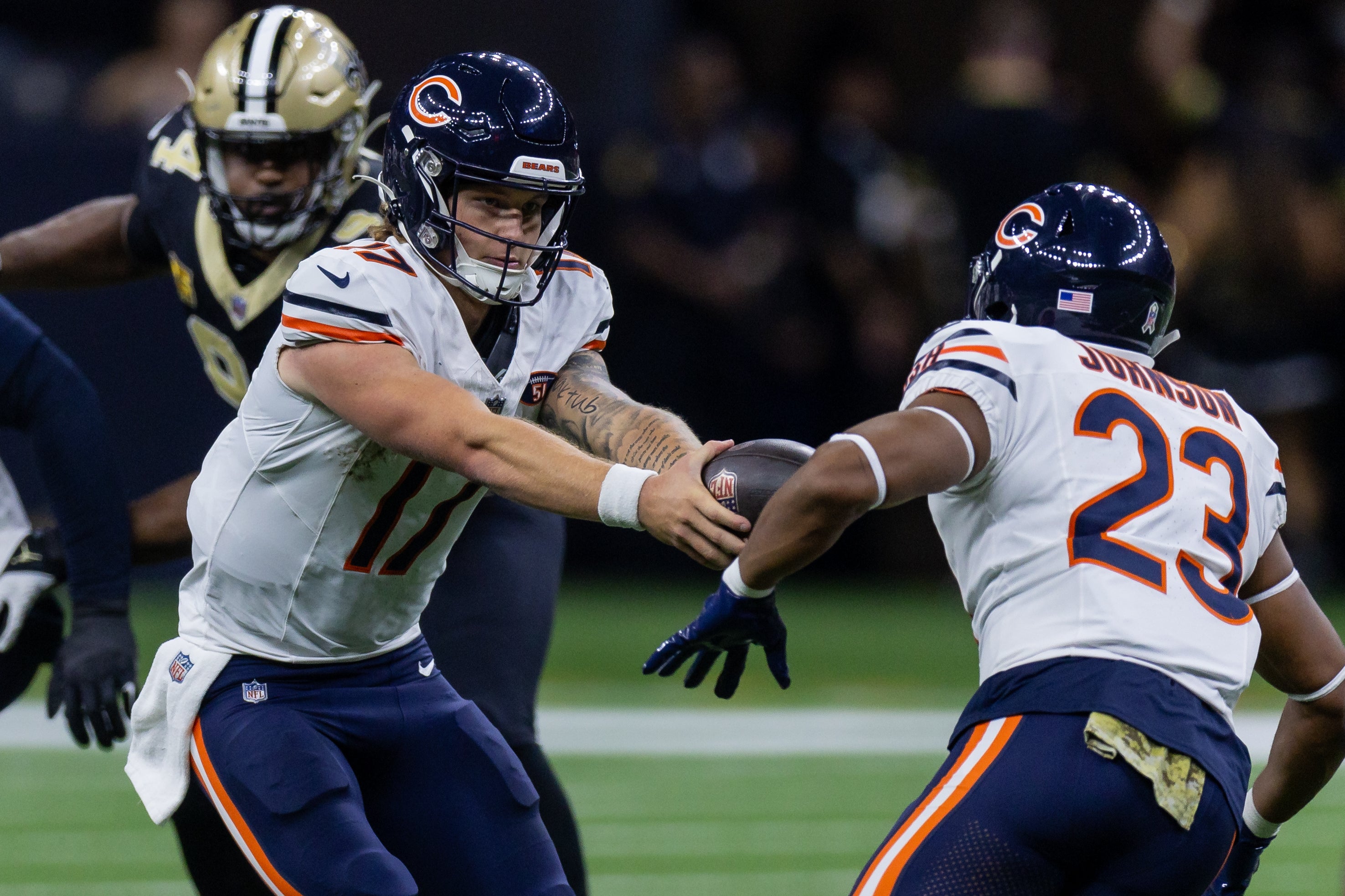 Nov 5, 2023; New Orleans, Louisiana, USA; Chicago Bears quarterback Tyson Bagent (17) hands the ball off to running back Roschon Johnson (23) against the New Orleans Saints during the first half at the Caesars Superdome.
